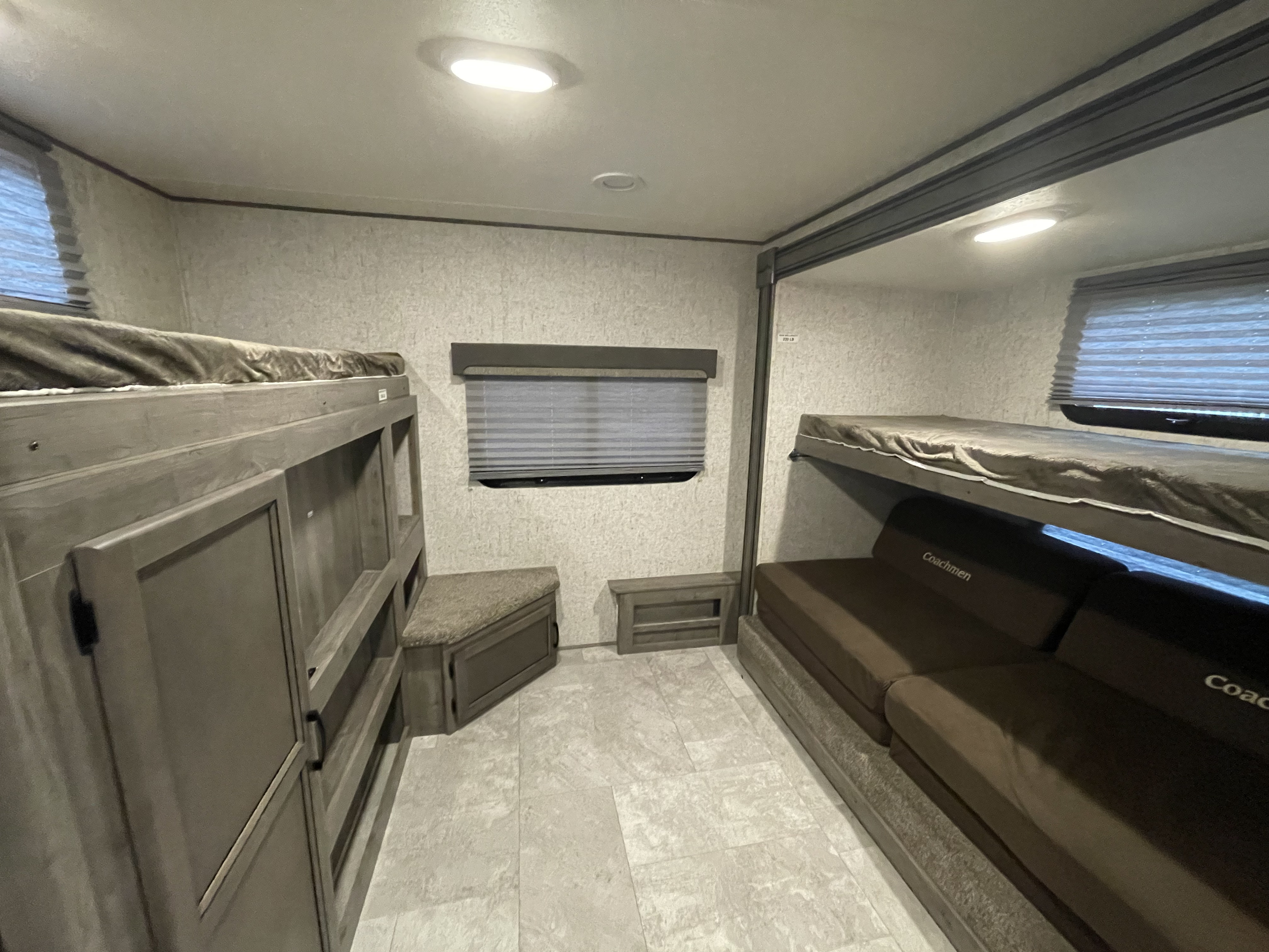 RV rental bunkhouse with two sets of bunks, sofa, window, and storage. Ideal for family travel.. Coachmen Apex 2019
