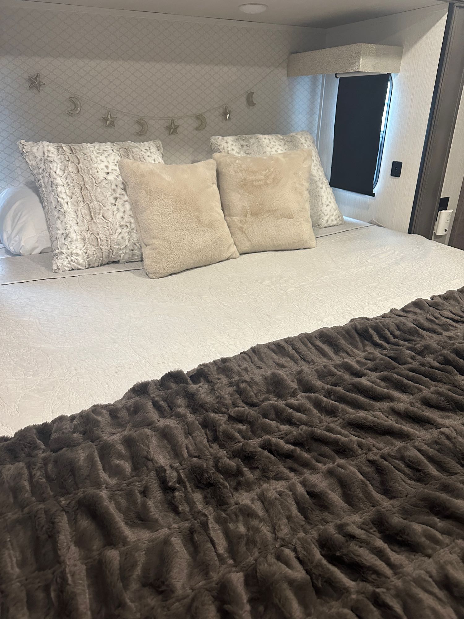 Inviting RV rental bedroom with a plush bed, soft pillows, and cozy faux fur blanket.. Cedar Creek Cedar Creek Fifth Wheel 2022