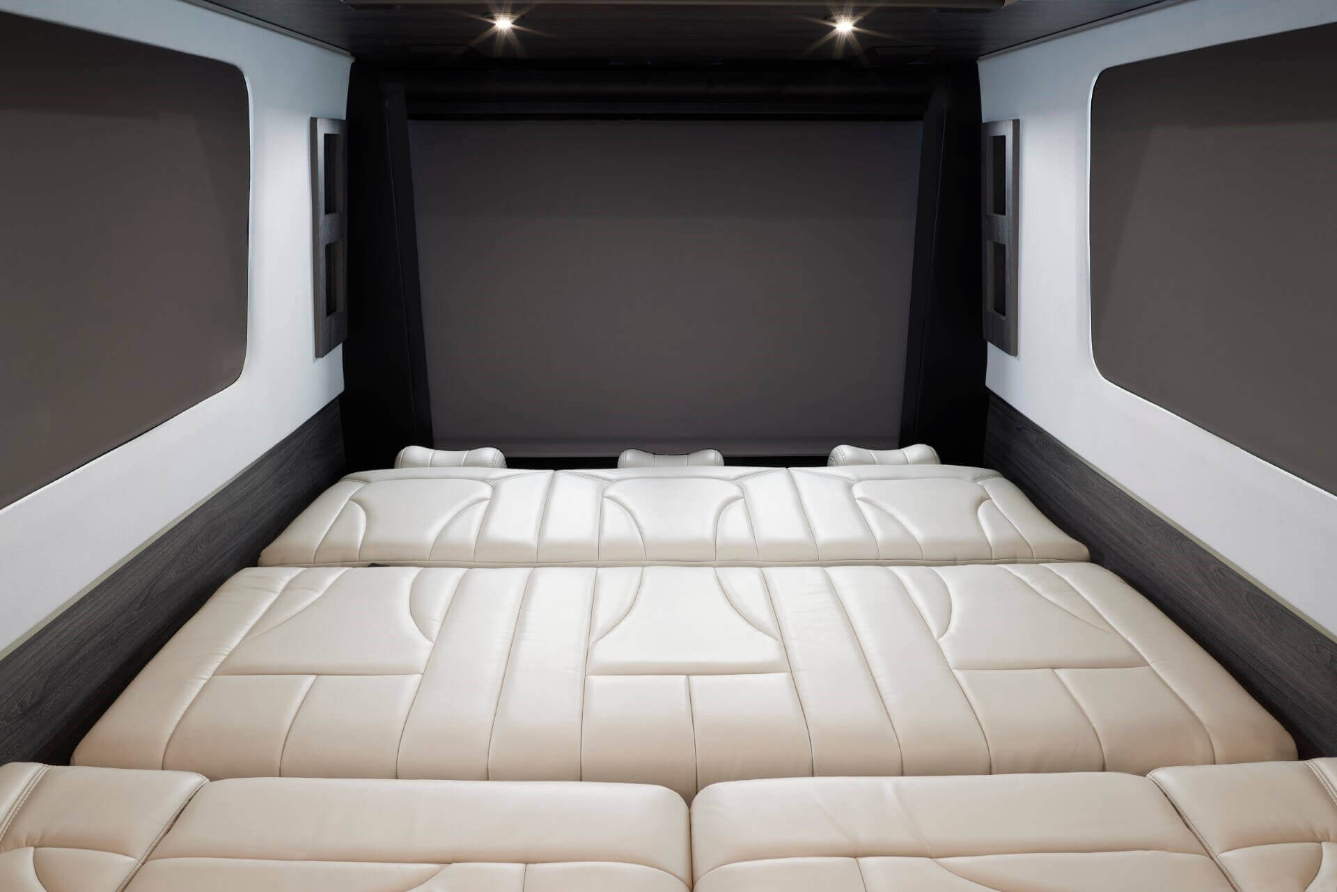 Comfortable RV rental interior: a spacious, cream-upholstered bed with sleek modern finishes.. Grech RV Strada 2023