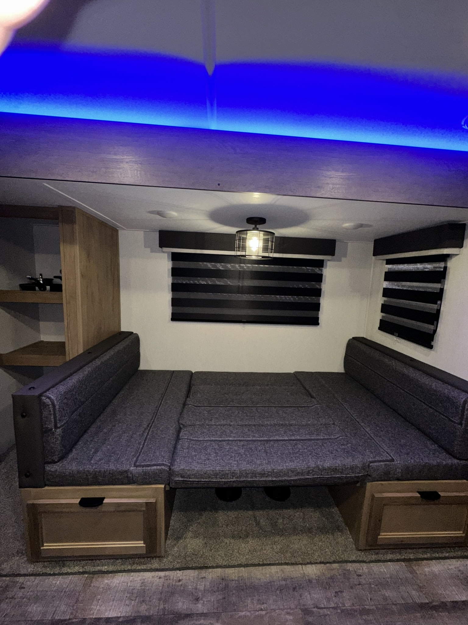 An RV rental's versatile interior: cozy dinette converts to a bed, with bright blue LED lighting and practical storage.. Forest River Wolf Pup 2024
