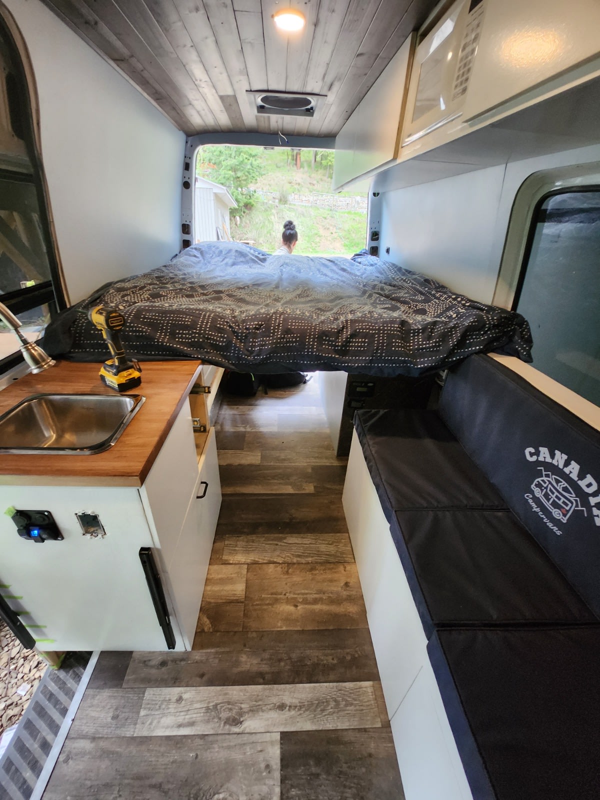 Cozy interior. Bed folds back into a couch and features a thick memory foam mattress.. Mercedes-Benz Sprinter 2012