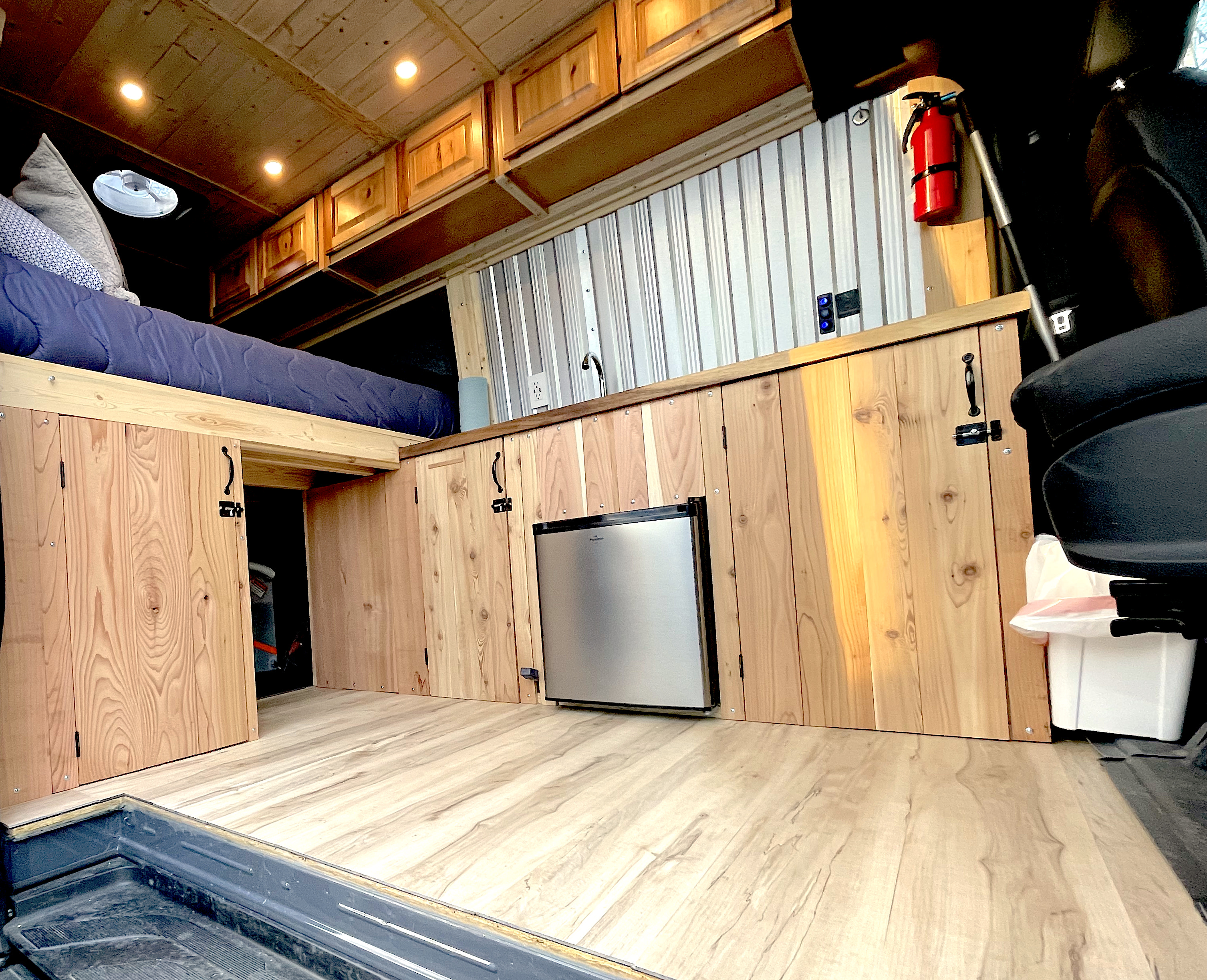 Experience this custom van conversion RV rental! Features a raised bed, compact kitchen, and smart storage solutions.. Mercedes Sprinter 2017