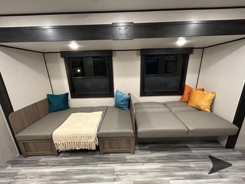 Spacious RV rental interior with modular seating and cozy cushions, ideal for relaxation.. Bish 26BHS 2024