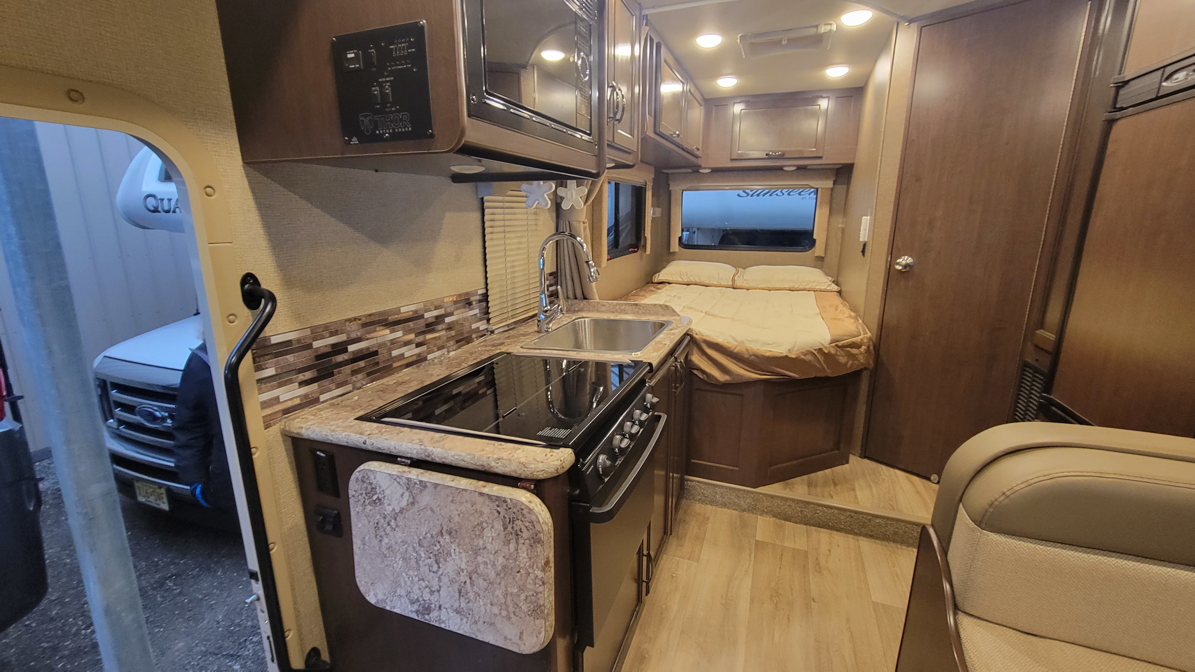 Discover this RV rental's interior: a full kitchen, cozy bedroom, and amenities by Thor Motor Coach. Ready for adventure.. Thor Freedom Elite 2018