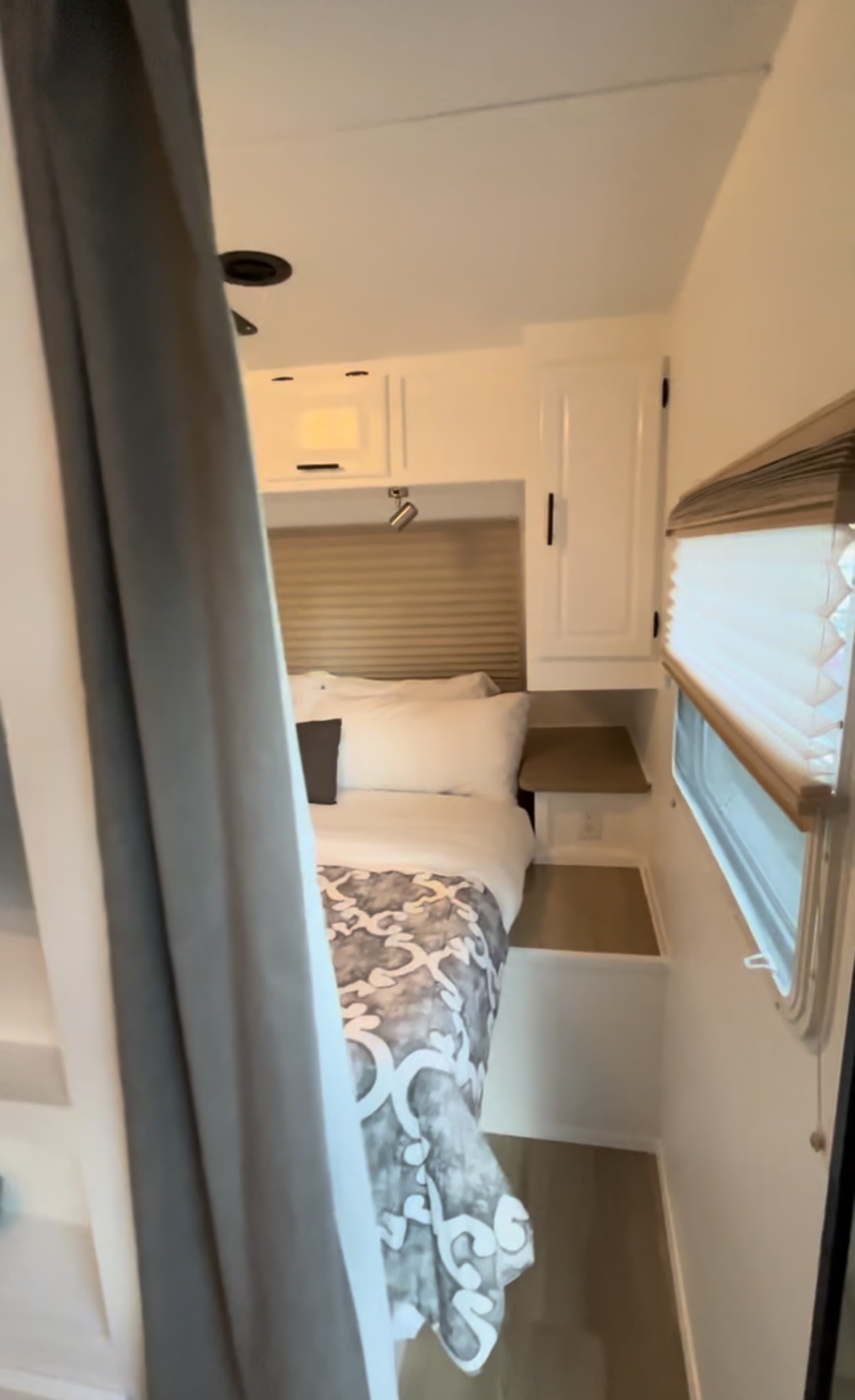 RV rental: The clean, compact bedroom with a bed, white cabinets, window blinds, and a privacy curtain.. Rockwood Elite light 2009