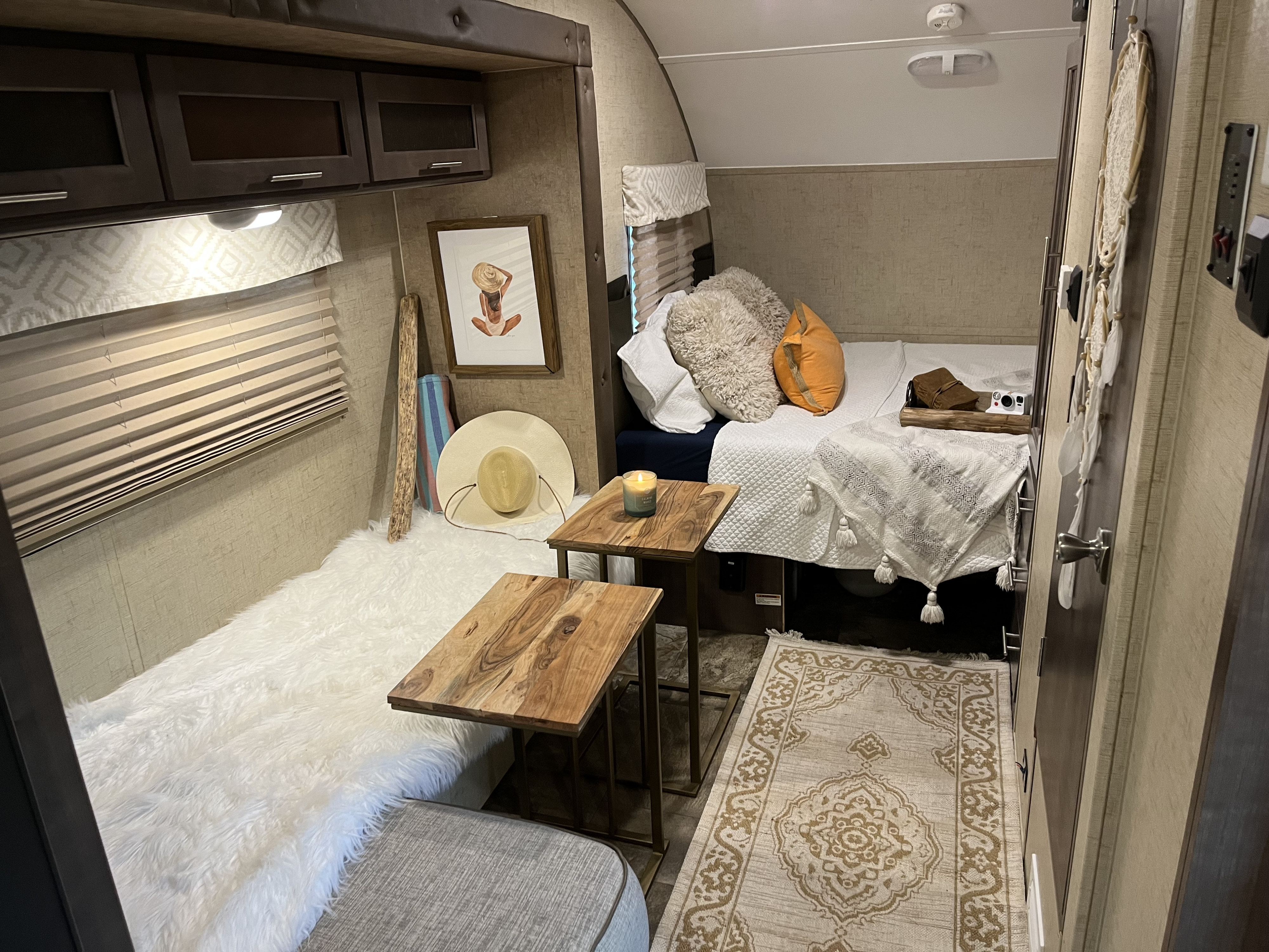 Relax in this modern RV rental interior featuring a cozy bed, stylish decor, and practical storage solutions.. R-Pod Hood River Edition 2016