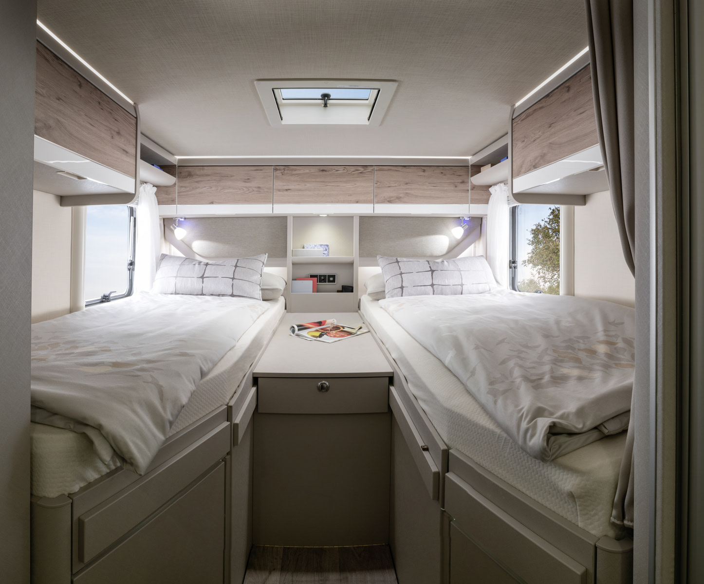 Twin beds and ample storage in a cozy RV rental bedroom, perfect for comfortable travel and adventure.. Hymer Exis I 678 2024