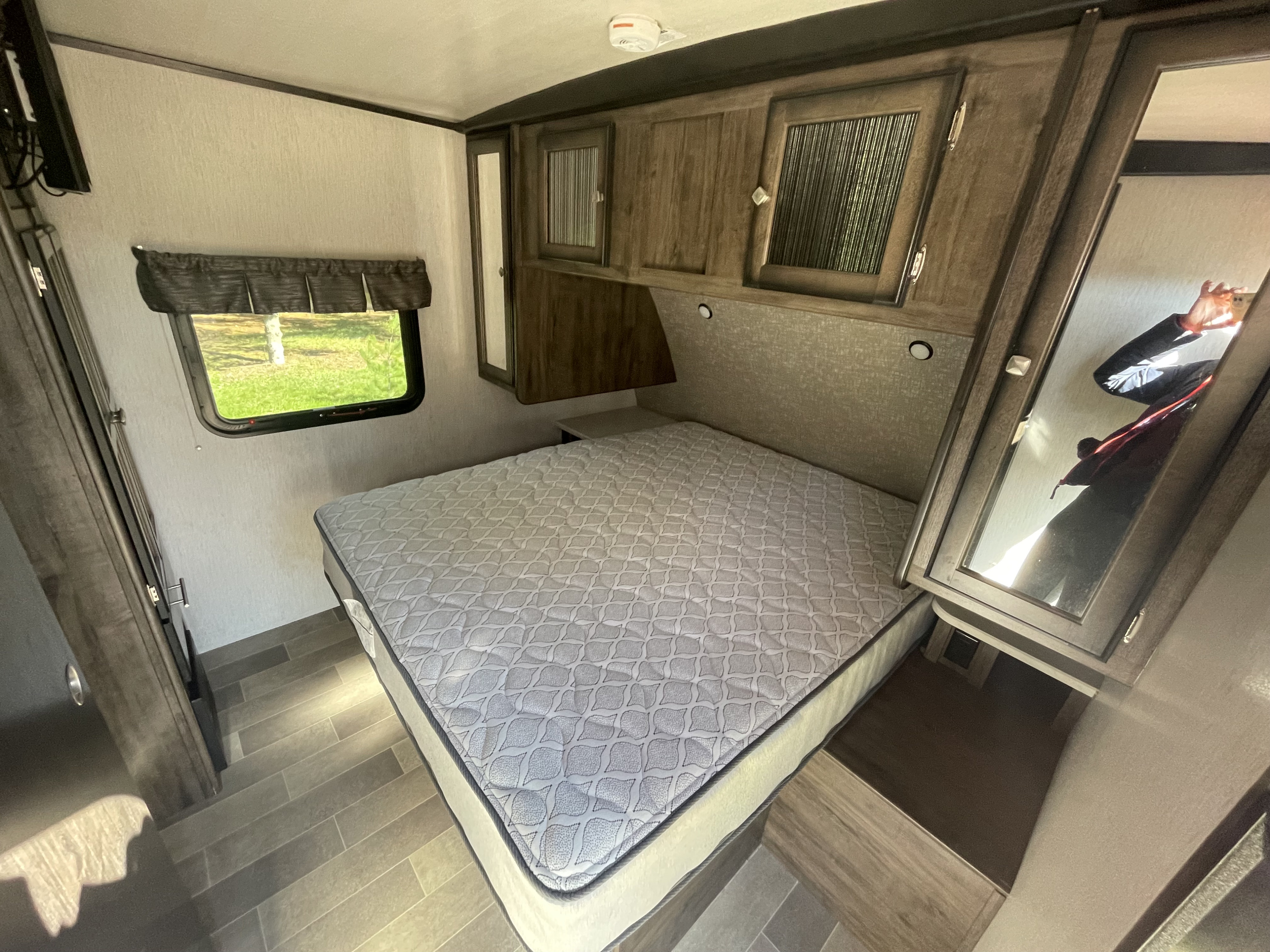 RV rental: Comfortable bedroom featuring a queen bed, overhead storage, window, and TV.. Heartland RVs Mallard 2019
