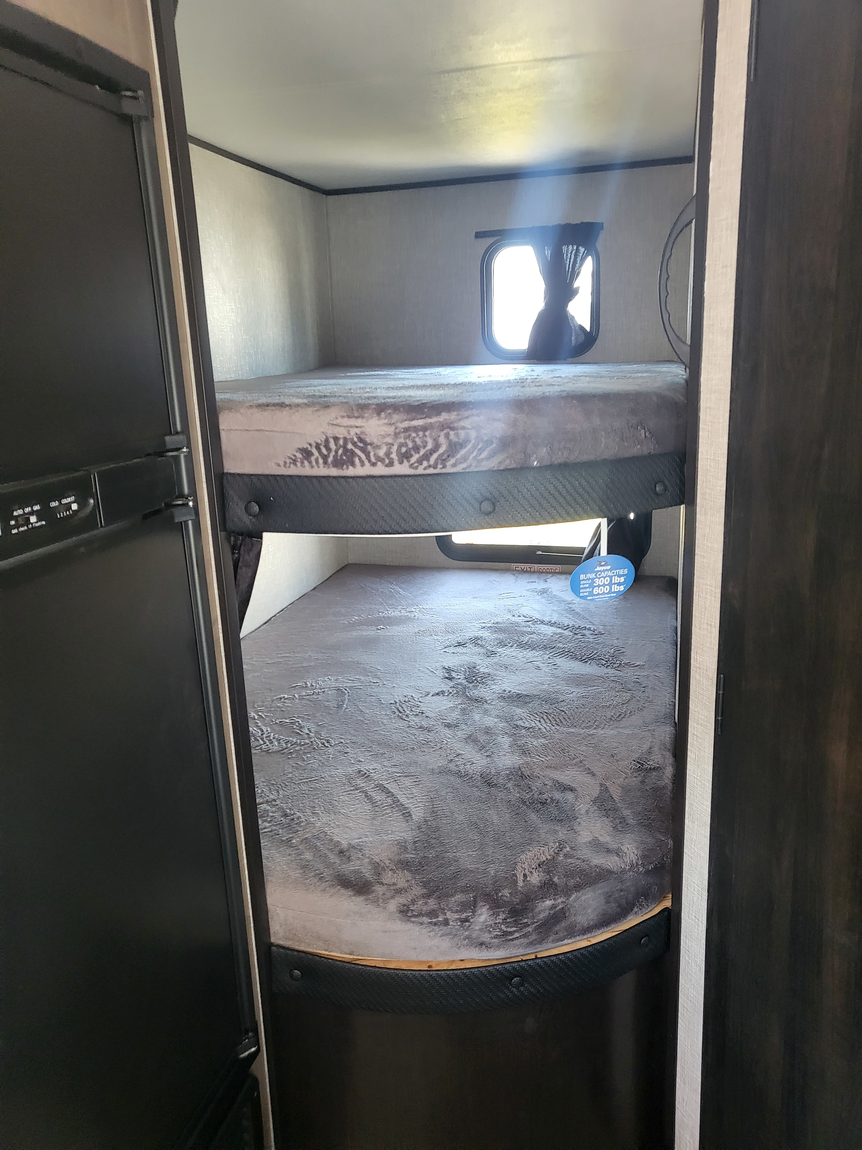 Inside an RV rental: two comfy bunk beds.. Jayco Jay Flight 2022