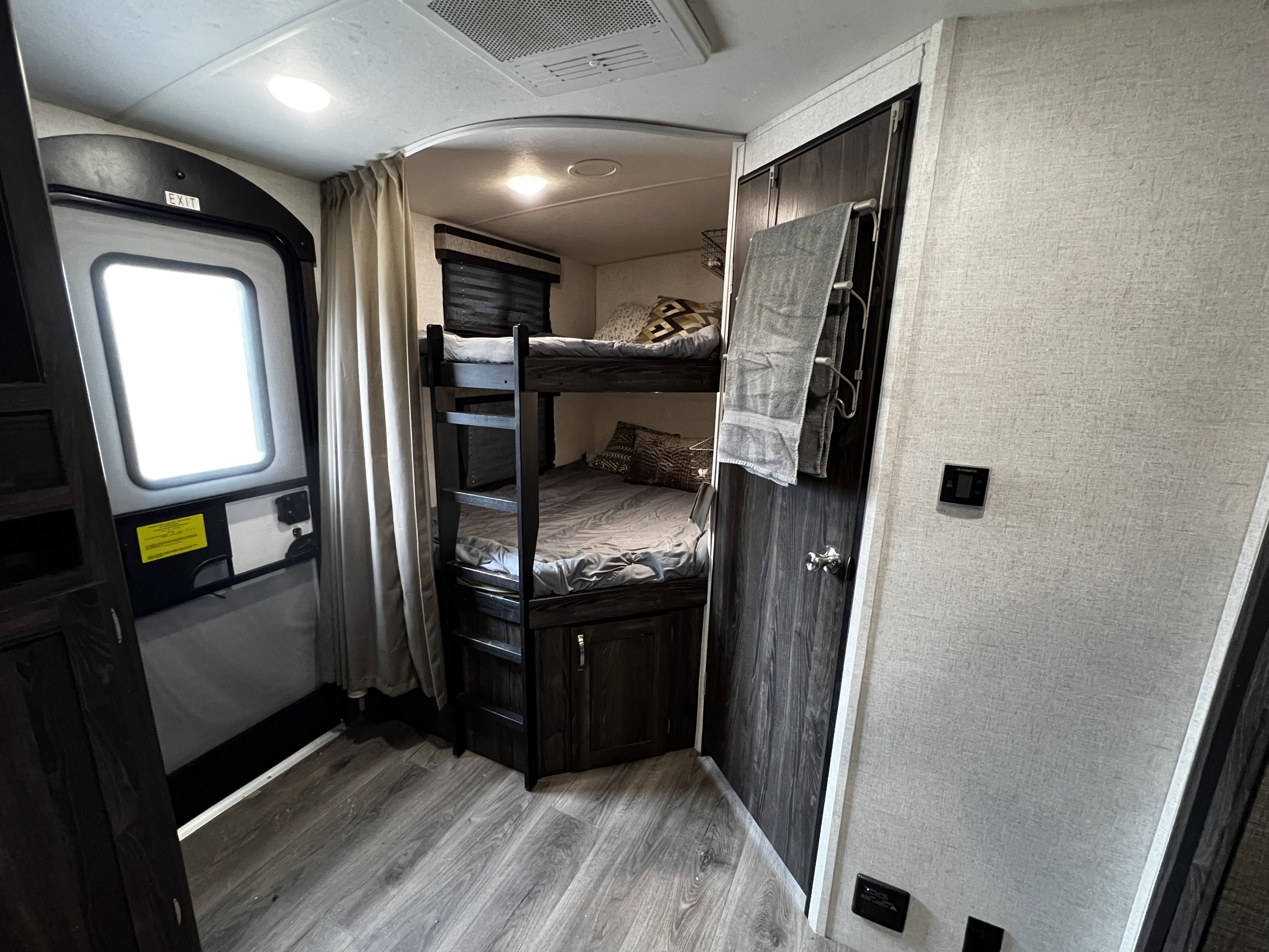 Inside this **RV rental**: comfortable bunk beds, an exterior exit, and a. Highland Ridge RV Mesa Ridge Lite 2020
