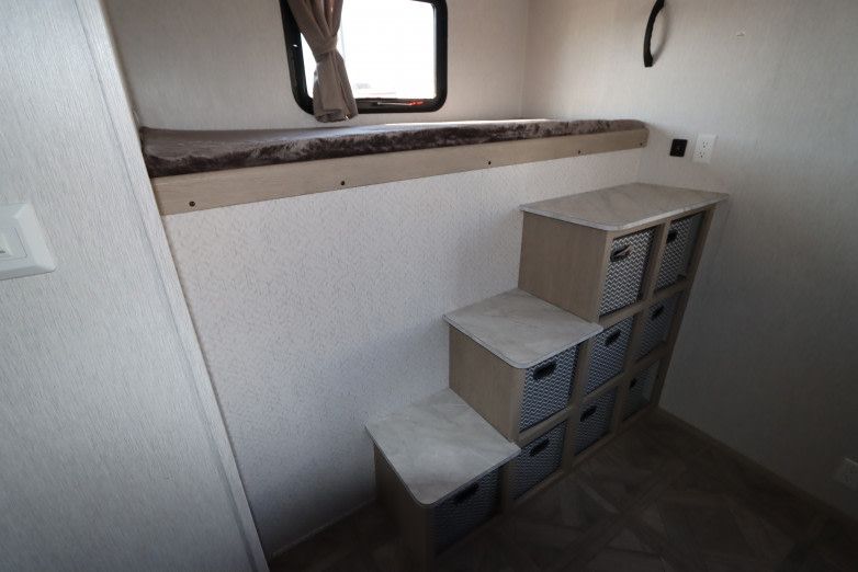 RV rental: Bunk bed with storage steps and baskets optimize space in this compact interior.. Forest River Salem 2023