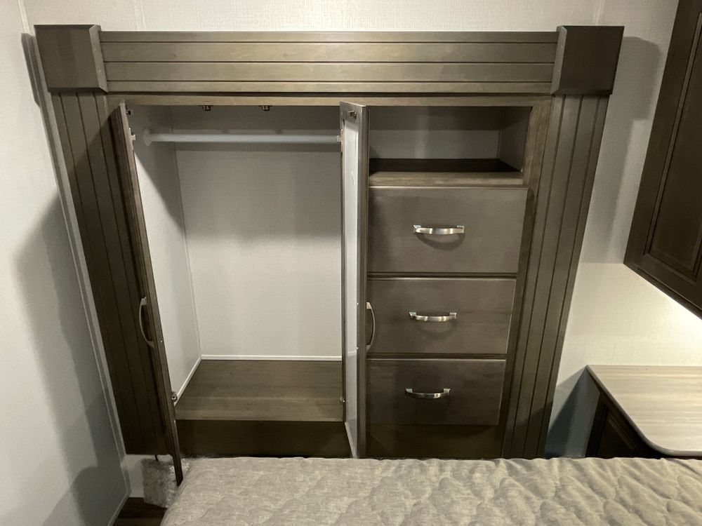 RV rental interior: Built-in bedroom wardrobe with hanging space & three drawers, providing essential storage for your trip.. Other Other 2024