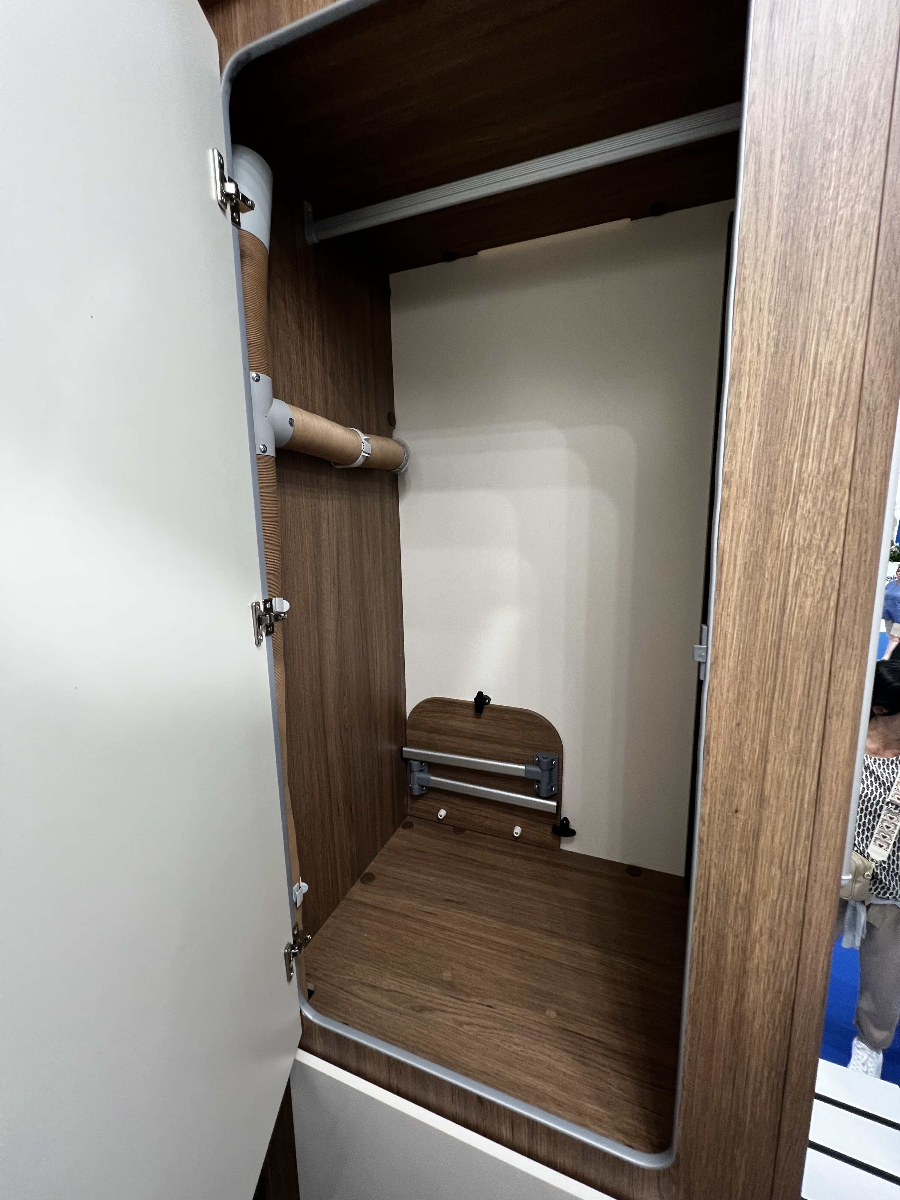 RV rental: This compact RV wardrobe provides a hanging bar, side heating duct, and fold-down shelf for efficient storage.. Elnagh Baron 20 2023