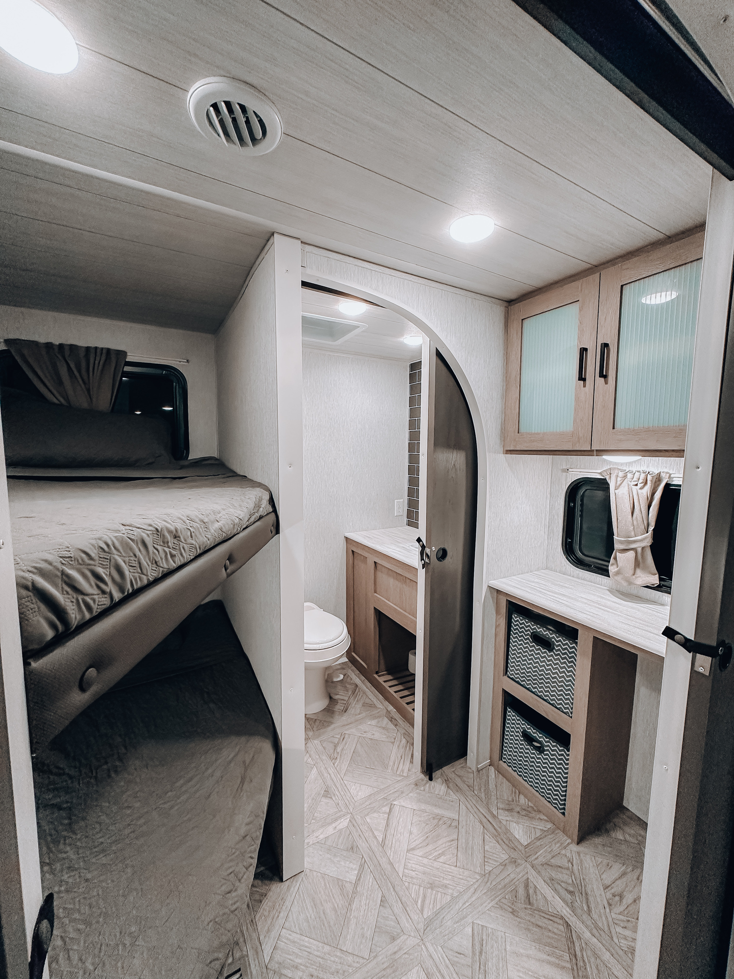 Explore this RV rental's clever interior: cozy bunk beds, a compact bathroom, and smart storage for your family adventures.. Forest River Wildwood Platinum 2024