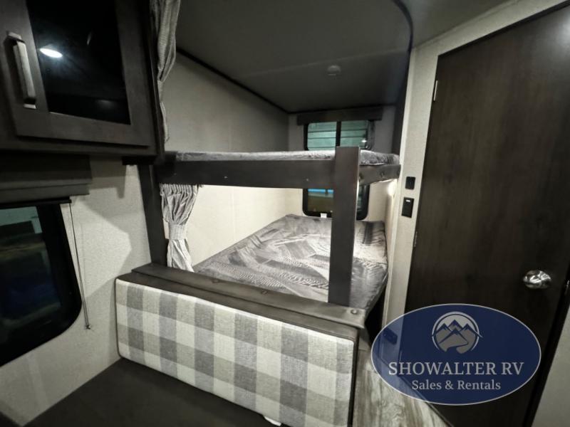 RV rental interior features cozy bunk beds, plaid seating, and storage cabinets.. Grand Design Transcend Xplor 2022