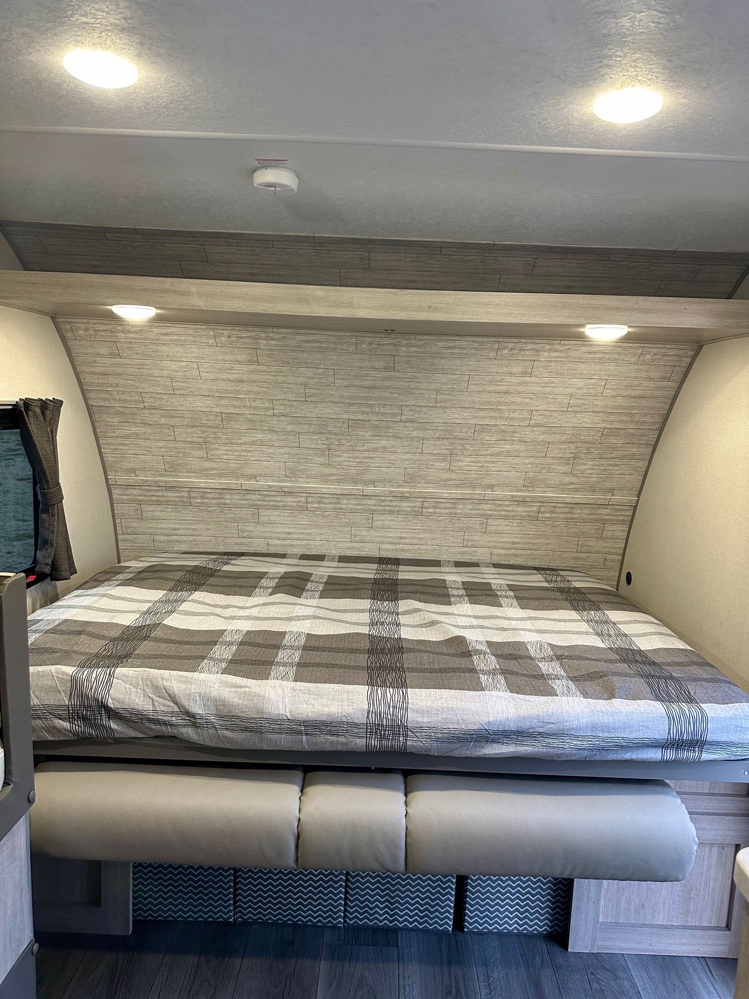 Cozy RV rental bedroom with comfortable bed, integrated seating, and overhead lighting. Perfect for travel!. Coachmen RV Catalina Summit Series 7 2024
