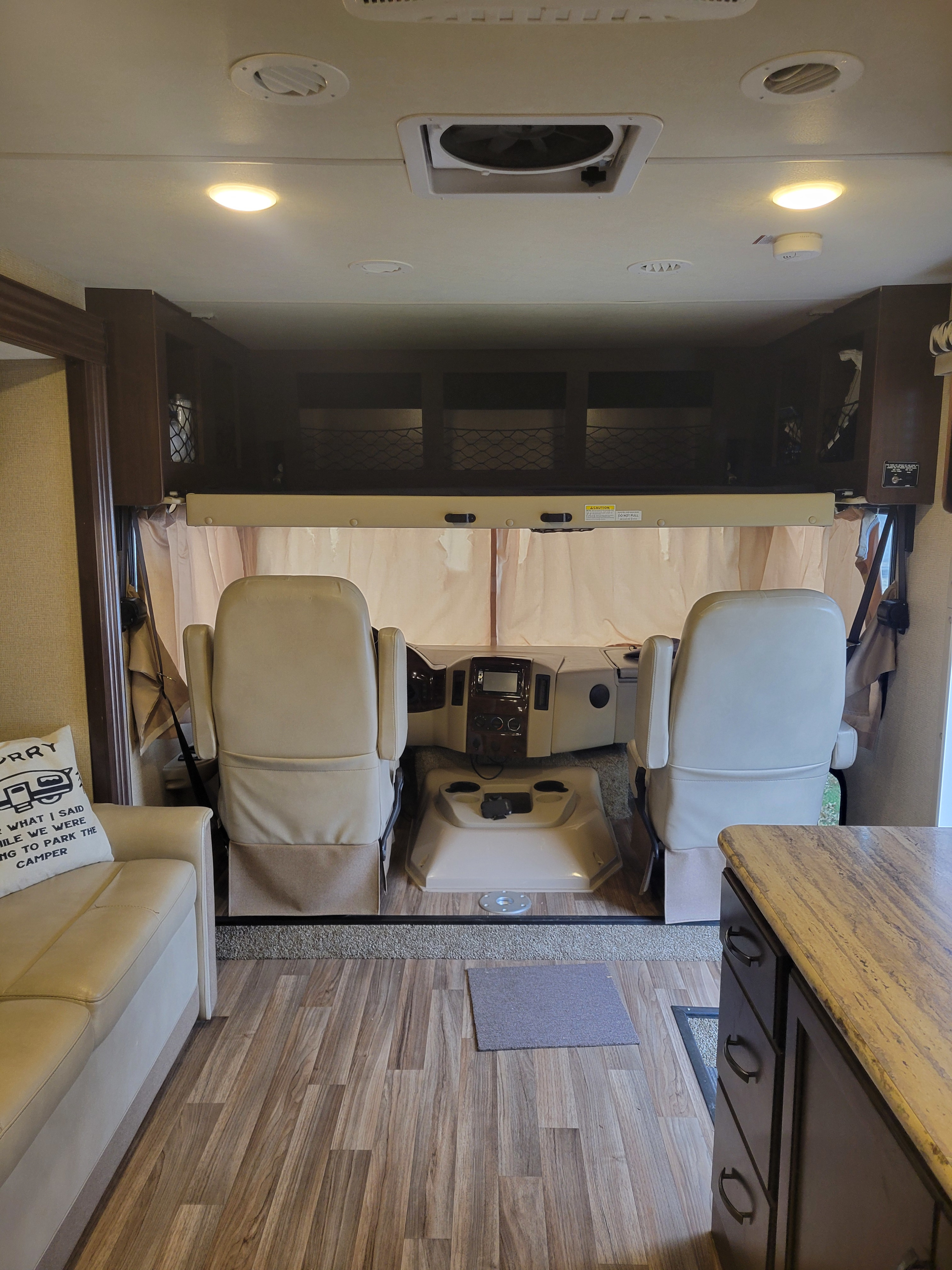Explore the inviting interior of this RV rental, featuring a comfortable cockpit, overhead bunk, and cozy living area.. Thor A.C.E. 2018
