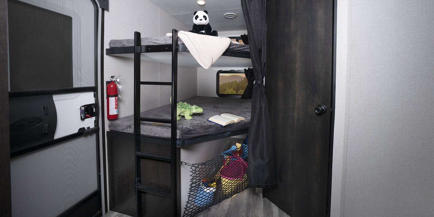 This RV rental features cozy bunk beds, a scenic window, fire extinguisher, and mesh storage for essentials.. Starcraft Super Lite 2022