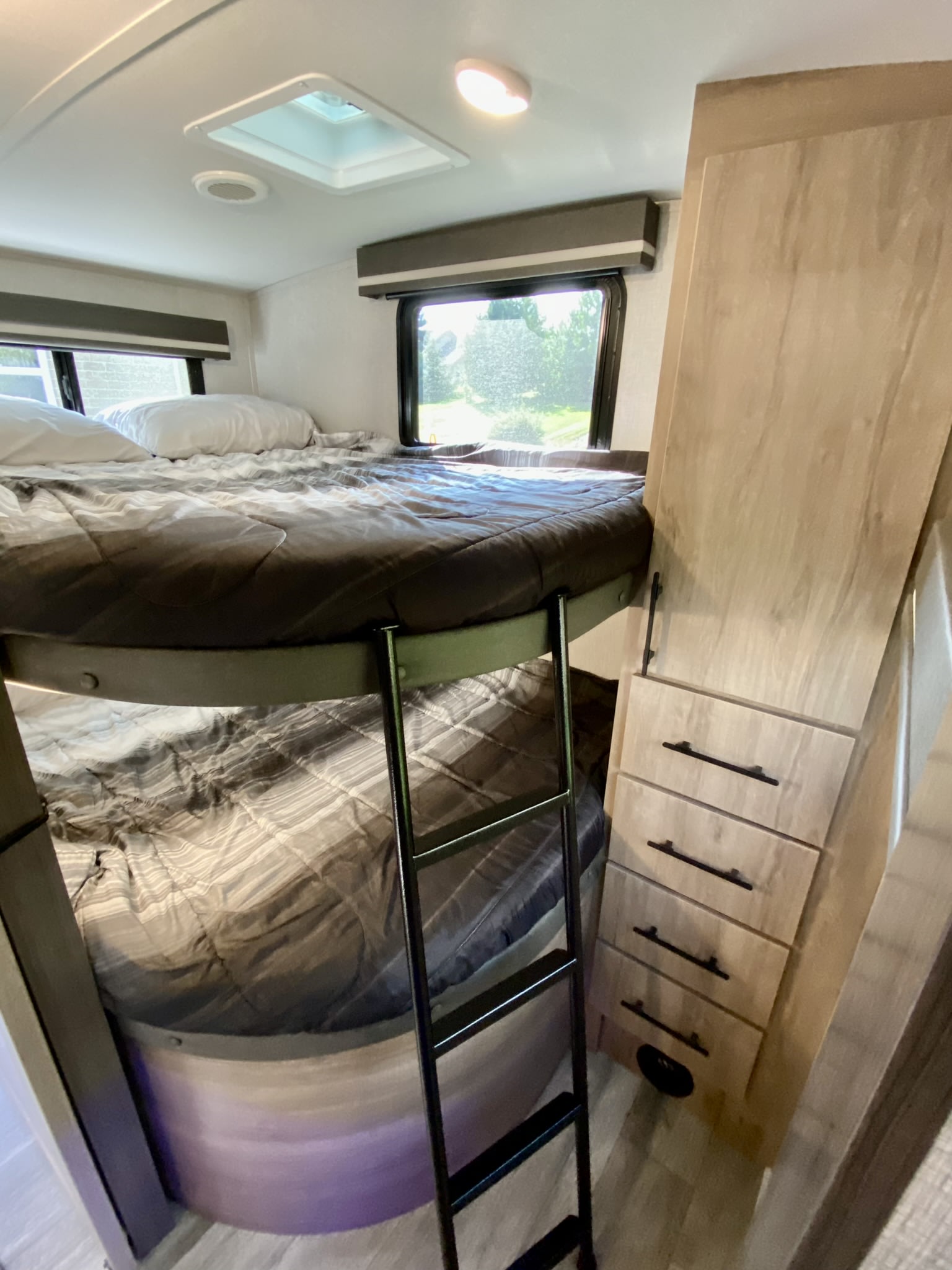 RV rental with cozy double bunk beds, ladder, built-in storage, & bright windows. Perfect family sleeping area.. Grand Design Imagine 2023
