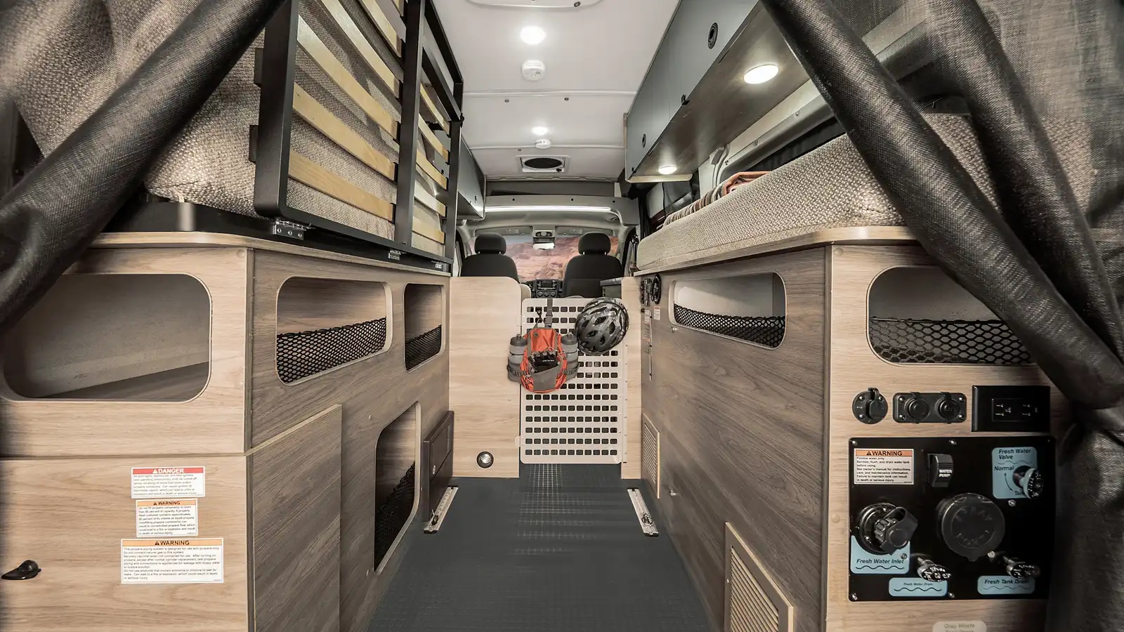 Spacious rv rental interior showing sleeping areas, organized storage, and essential water system controls. Ready for adventure.. Winnebago Solis Pocket 2022