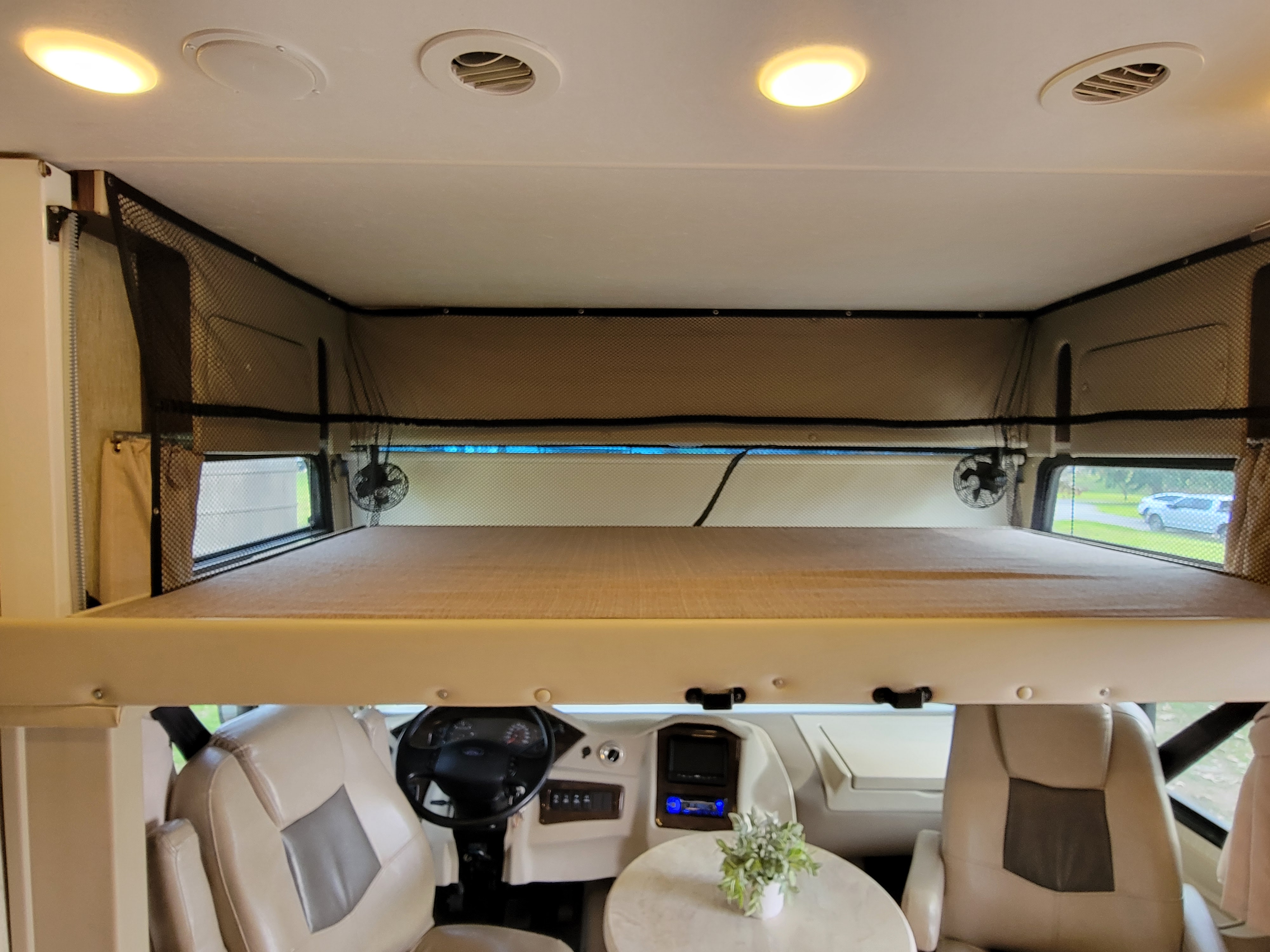 This RV rental's interior features a cozy overhead bunk bed, driver's cockpit, and comfortable seating for your adventures.. Coachmen Mirada 2018