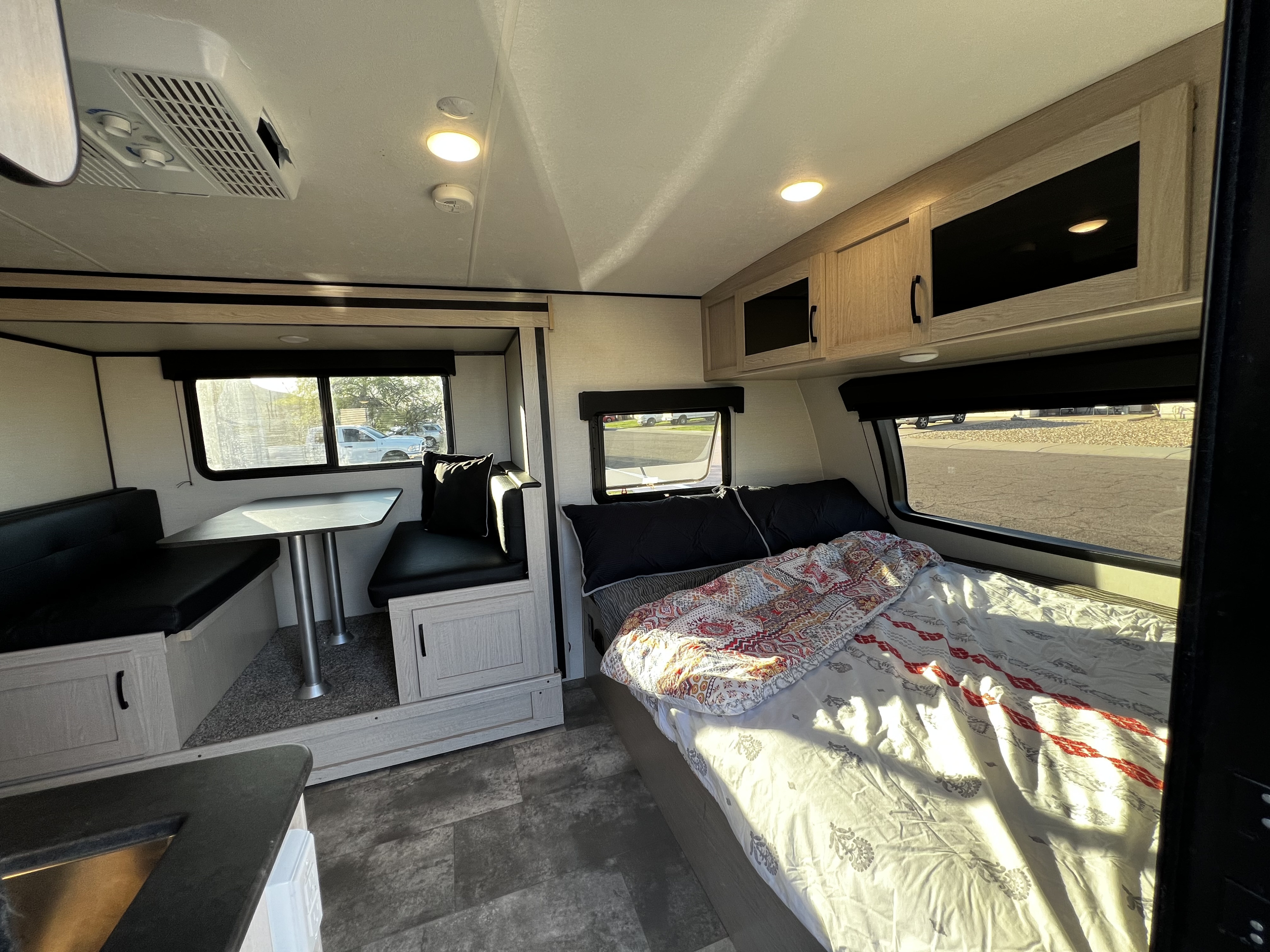 Spacious rv rental interior features comfy bed, dinette, and overhead storage, perfect for travel comfort.. Coachmen Apex Nano 2022