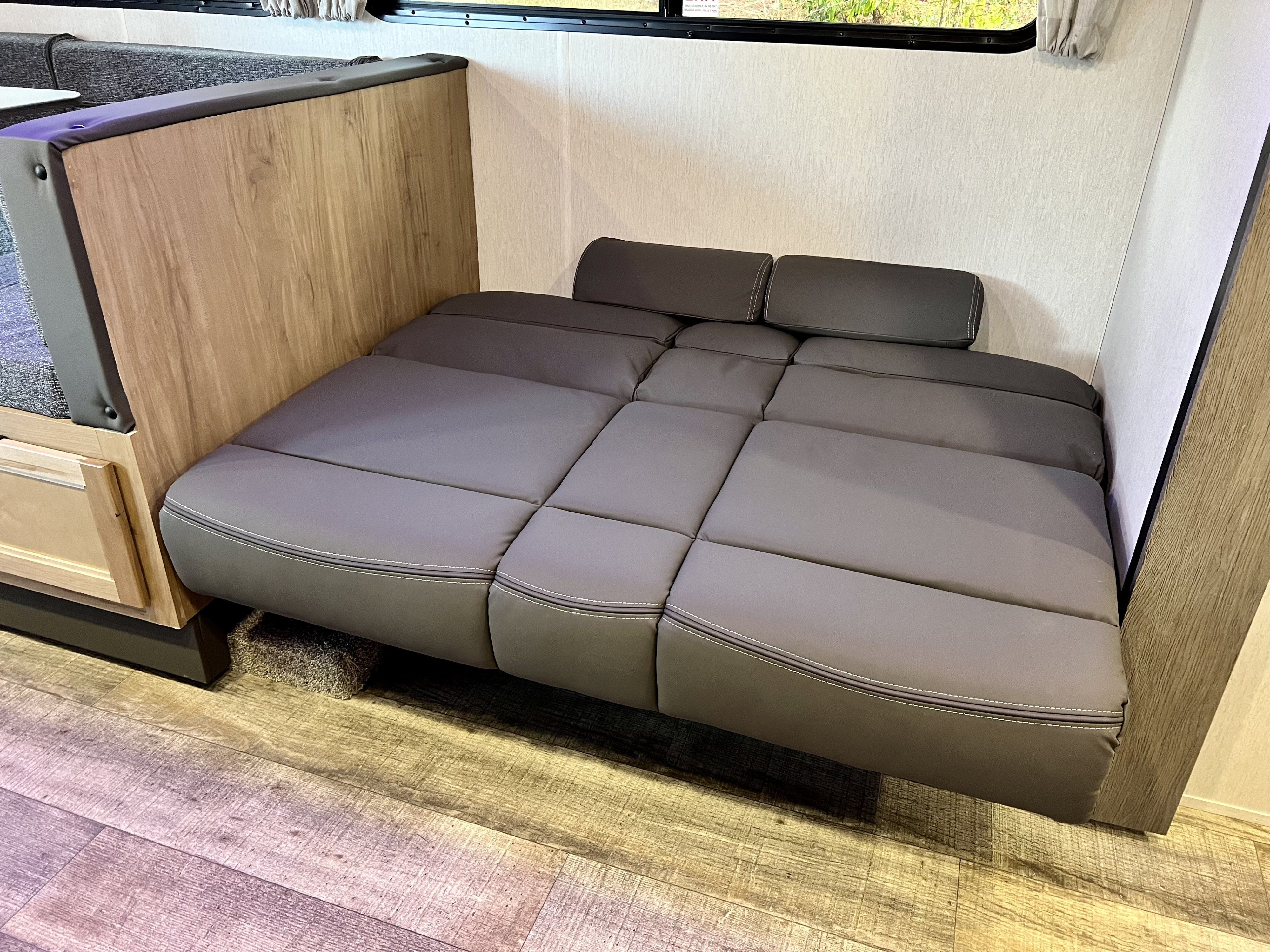 RV rental: Comfortable grey convertible dinette transformed into a bed, providing flexible sleeping space.. Forest River Cherokee Grey Wolf 2024