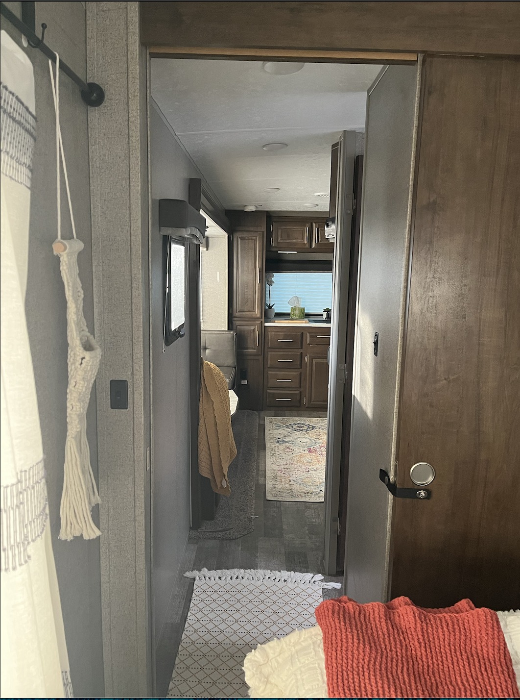 Step inside this inviting RV rental. A narrow hall leads to a kitchen/living area. Macrame decor, rugs & cozy bedding add charm.. Forest River Rockwood Mini Lite 2019