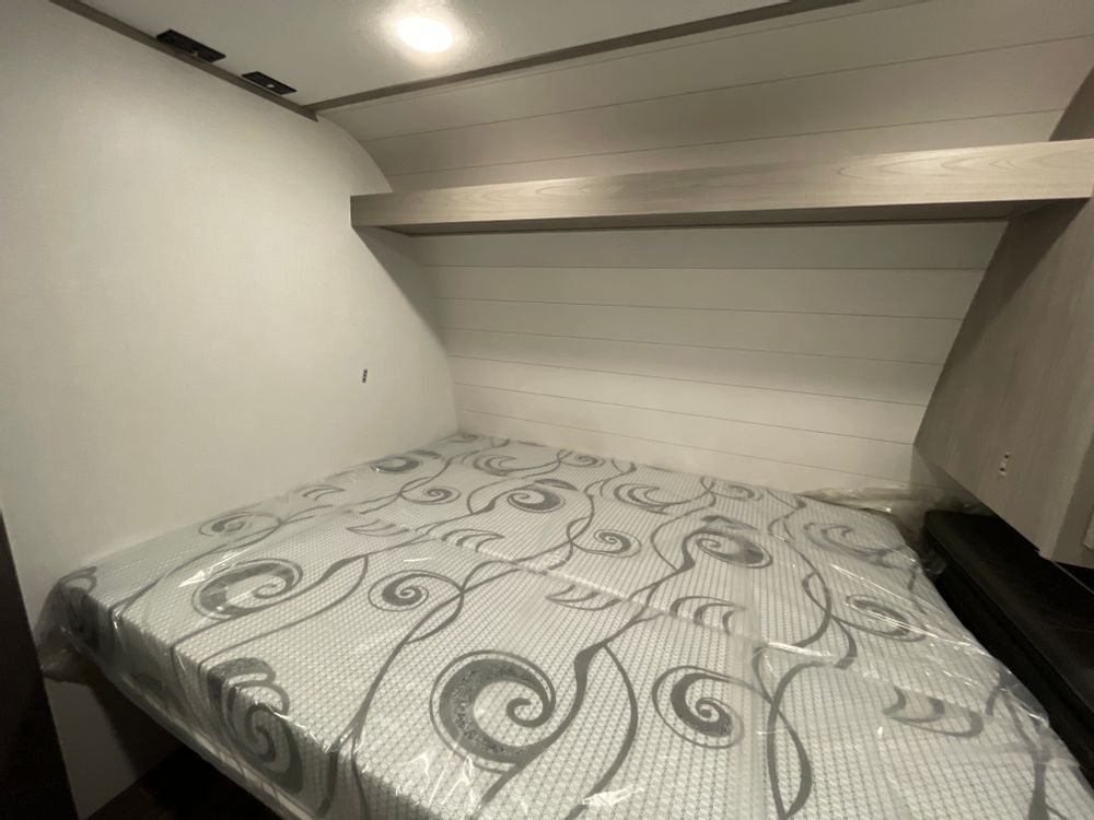 Queen bed located at the front of the trailer. (Picture before tv was added). . Coleman Lantern LT 19bb 2024