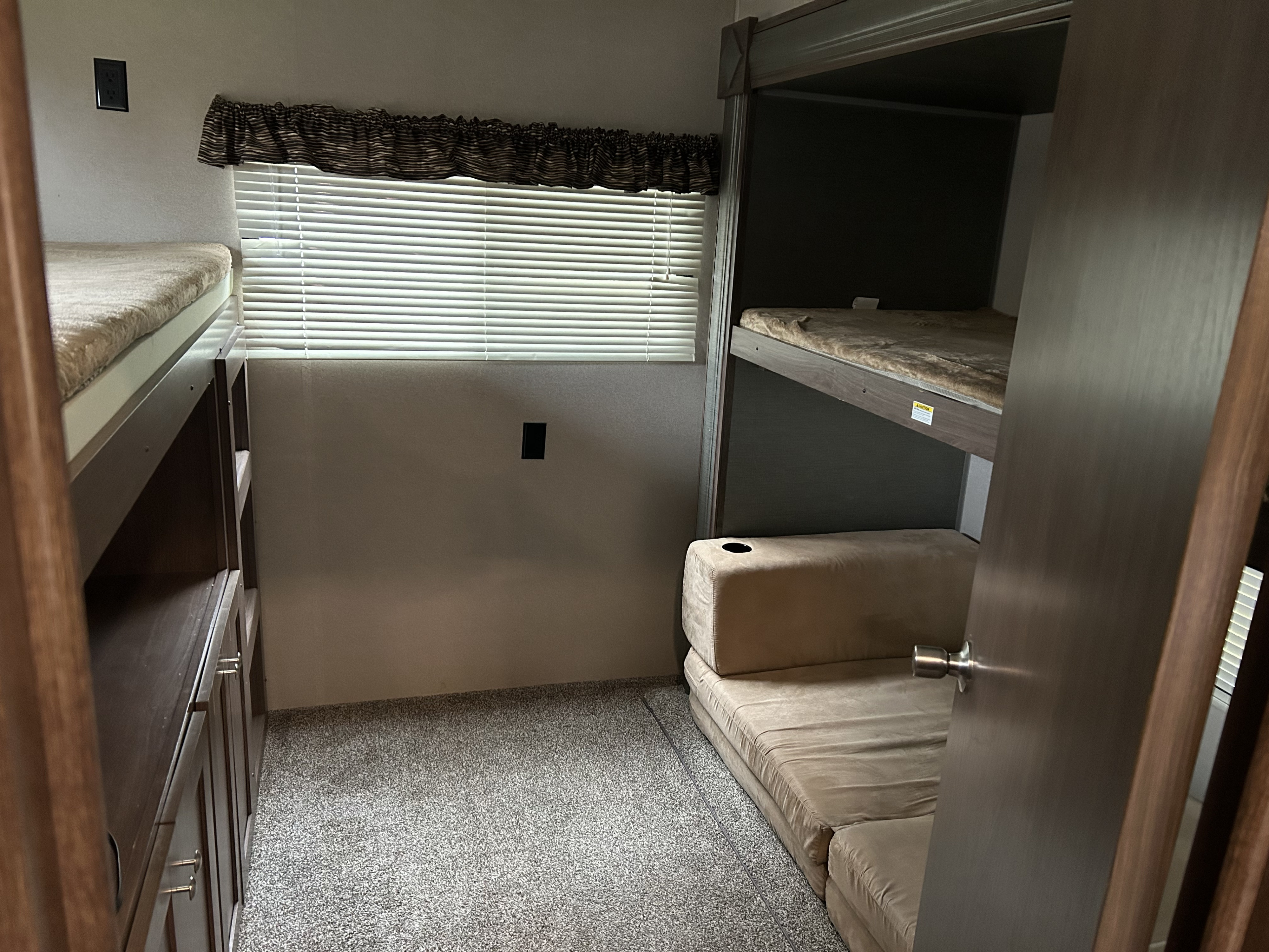RV rental bunk room: Cozy sleeping area with twin bunk beds, convertible sofa, and storage, perfect for families.. Keystone RV Hideout 2018