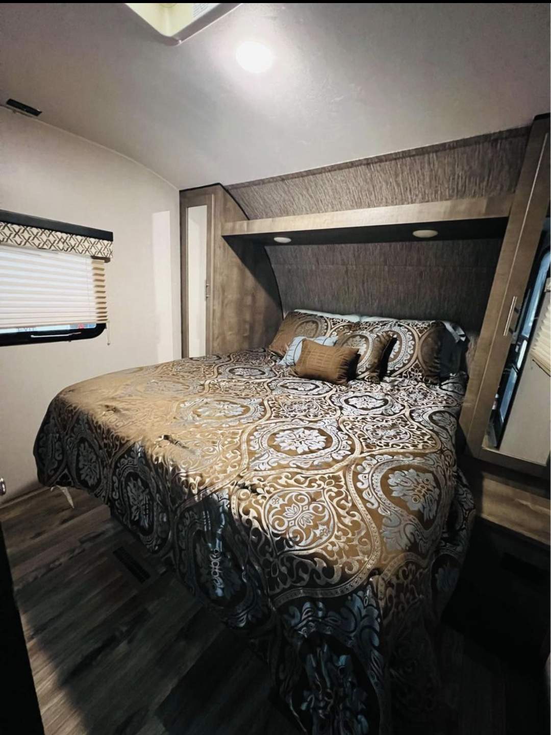 Cozy RV rental bedroom with patterned bedding & built-in storage. Ideal for travel comfort.. KZ Connect 2019