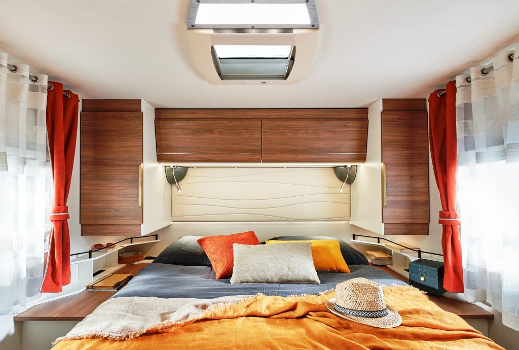 Modern RV rental bedroom featuring a comfy bed, overhead storage, and skylight for ultimate travel comfort.. Pilote G740 FC EVIDENCE 2025