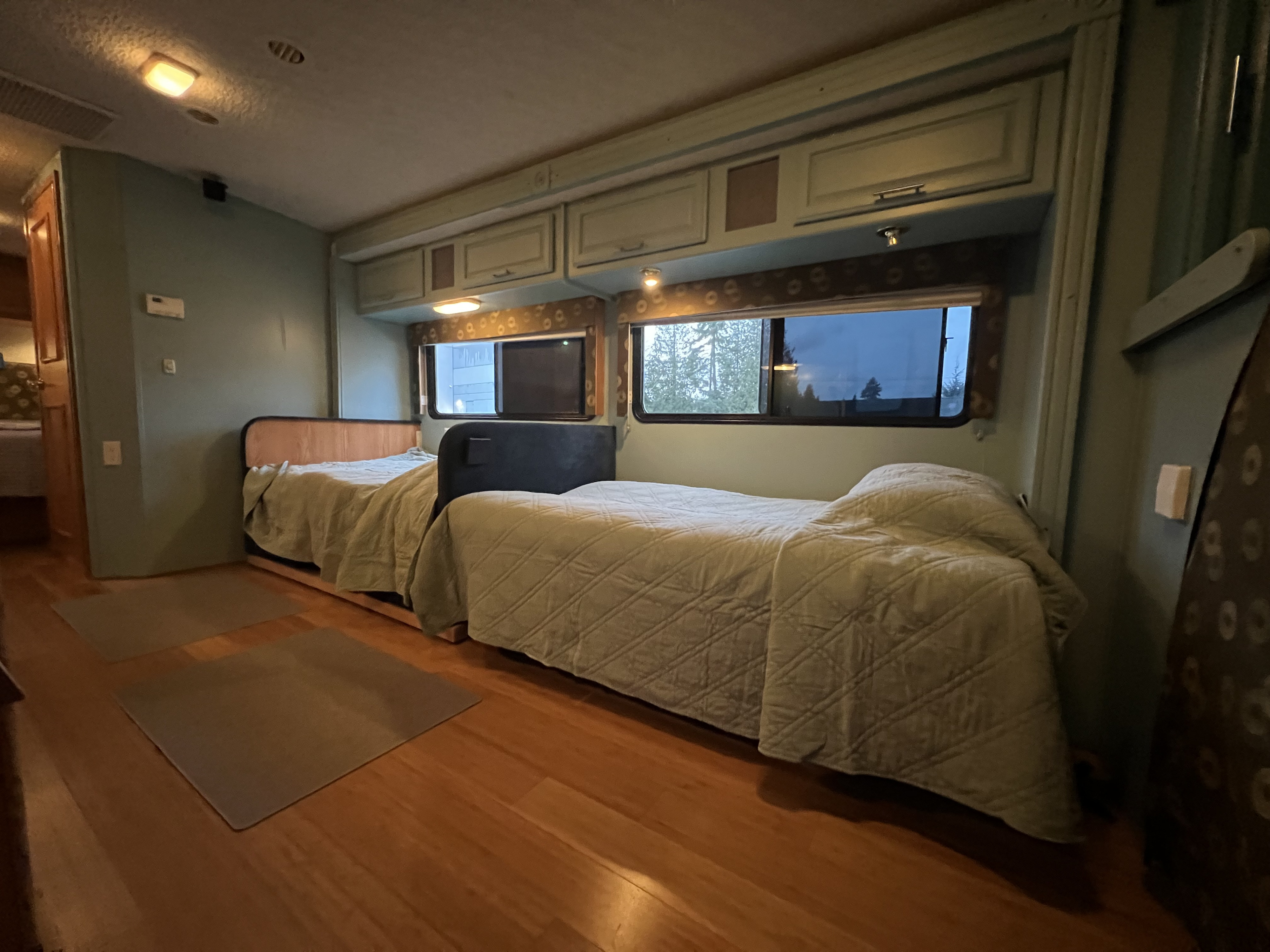 RV rental: Bedroom with two twin beds, light blue walls, wood floor, and scenic windows.. Winnebago Minnie Winnie 2003