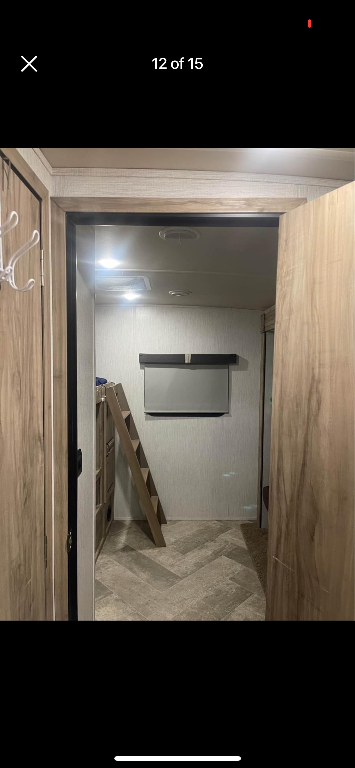 RV rental interior: A cozy bunk bed area with ladder, modern finishes, and herringbone floor.. Forest River Palomino Solaire 2021