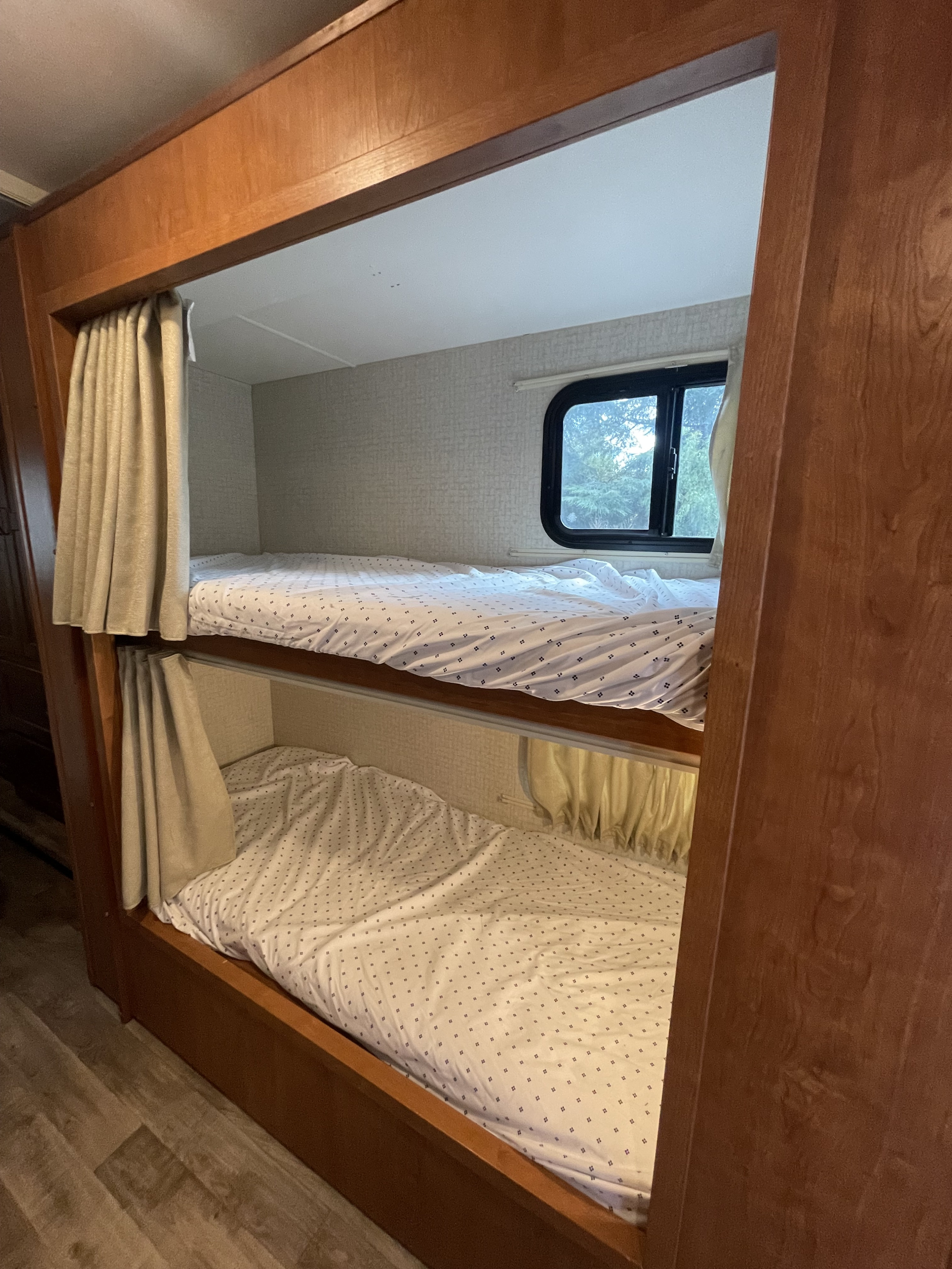Comfortable bunk beds with privacy curtains & window view in this RV rental.. Winnebago Minnie Winnie 2018