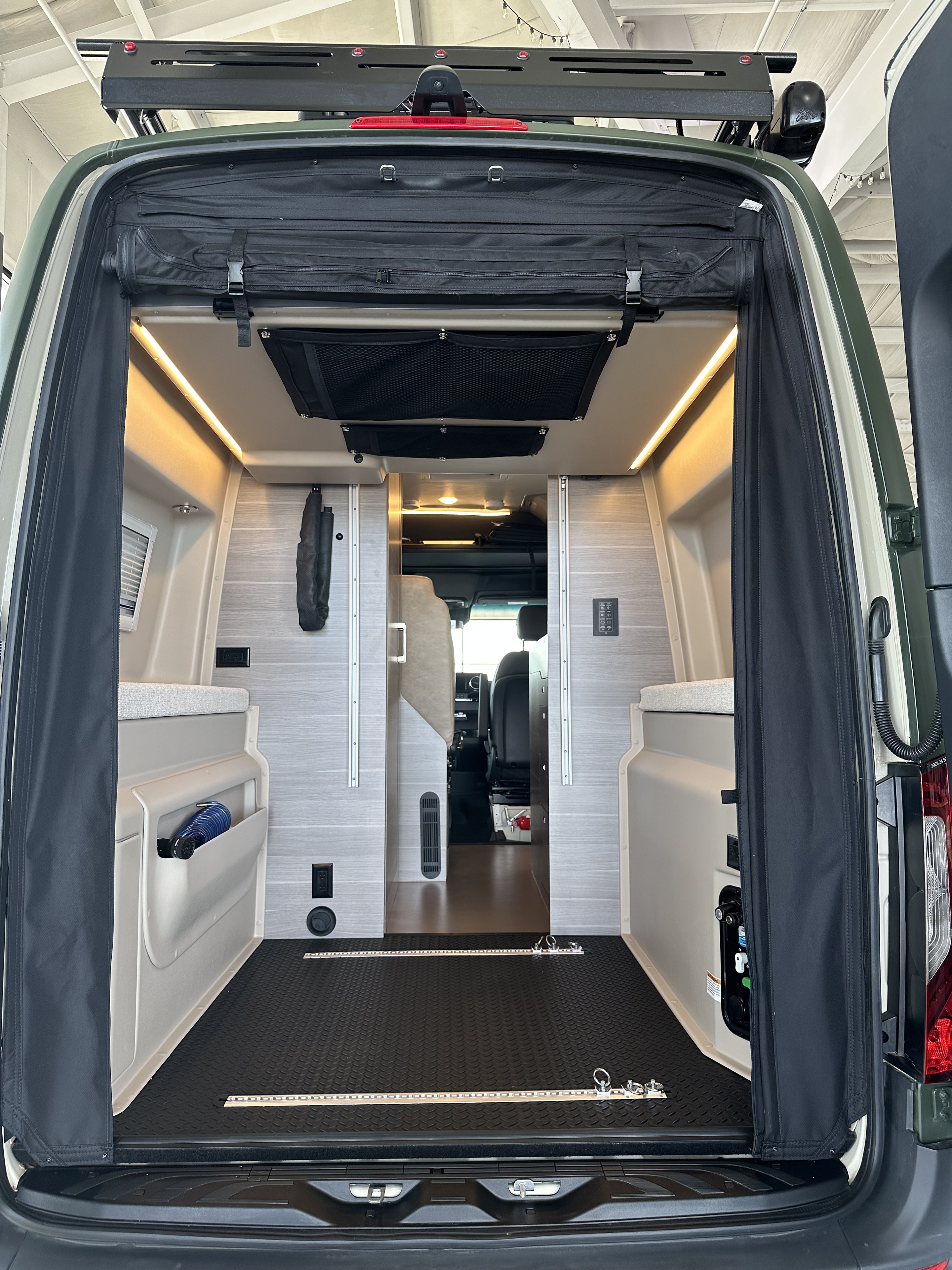 Discover this RV rental's spacious camper van interior! Organized storage, bright LEDs, and versatile tie-downs for adventure.. Mercedes-Benz Entegra Launch 2024