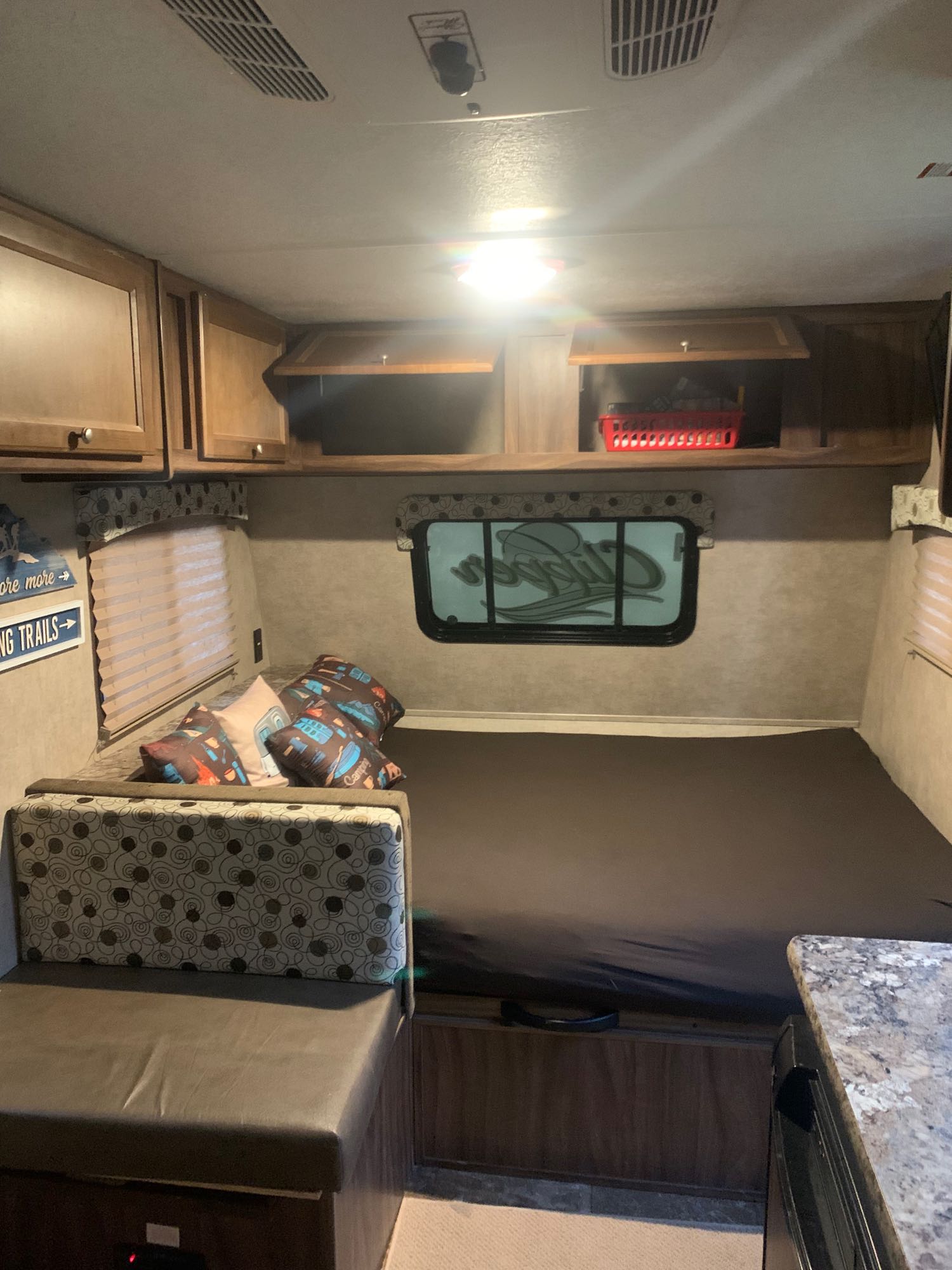 Inside this RV rental: a comfortable bed, dinette, and ample overhead storage. Ready for your next road trip adventure.. Coachmen Clipper 2016