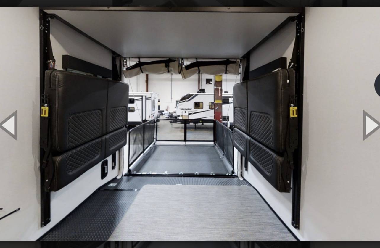 RV rental interior: This versatile garage space features fold-up seating/beds and durable utility flooring.. Heartland Torque 2022