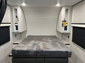 RV rental bedroom: a comfortable bed with side storage and window blinds, ready for your next adventure.. Jayco Jay Flight 235 MBHW 2024