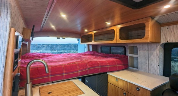 Experience comfort in this stylish rv rental. Full-size bed, modern kitchen, and sleek storage make van life easy.. Ford Transit Van 2023