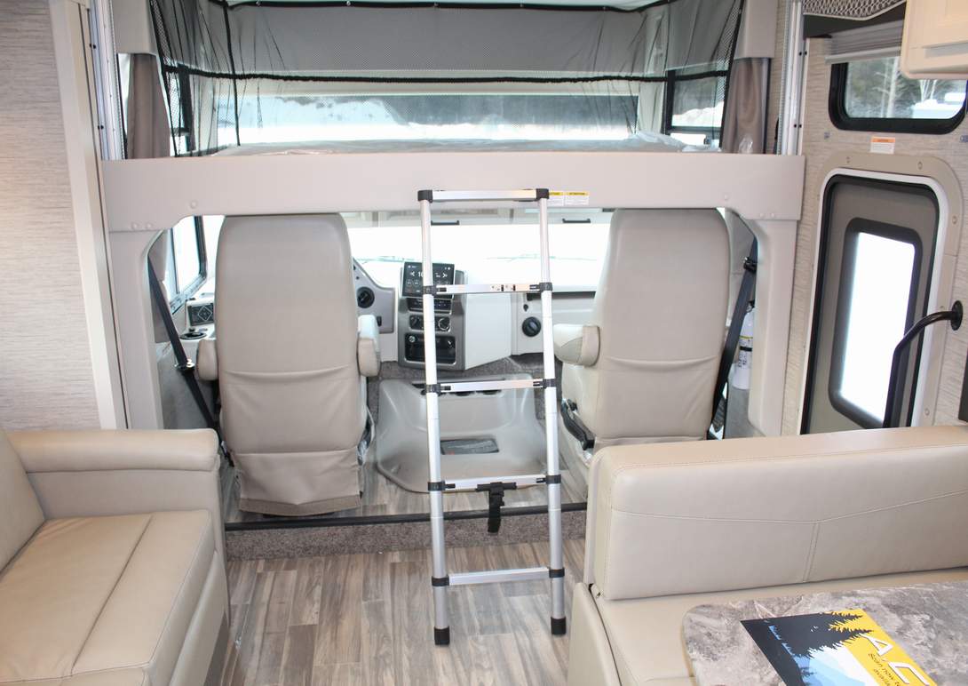 Explore a modern RV rental motorhome: comfy bunk, cockpit, and living area for road trip comfort.. Thor Motor Coach ace 2023