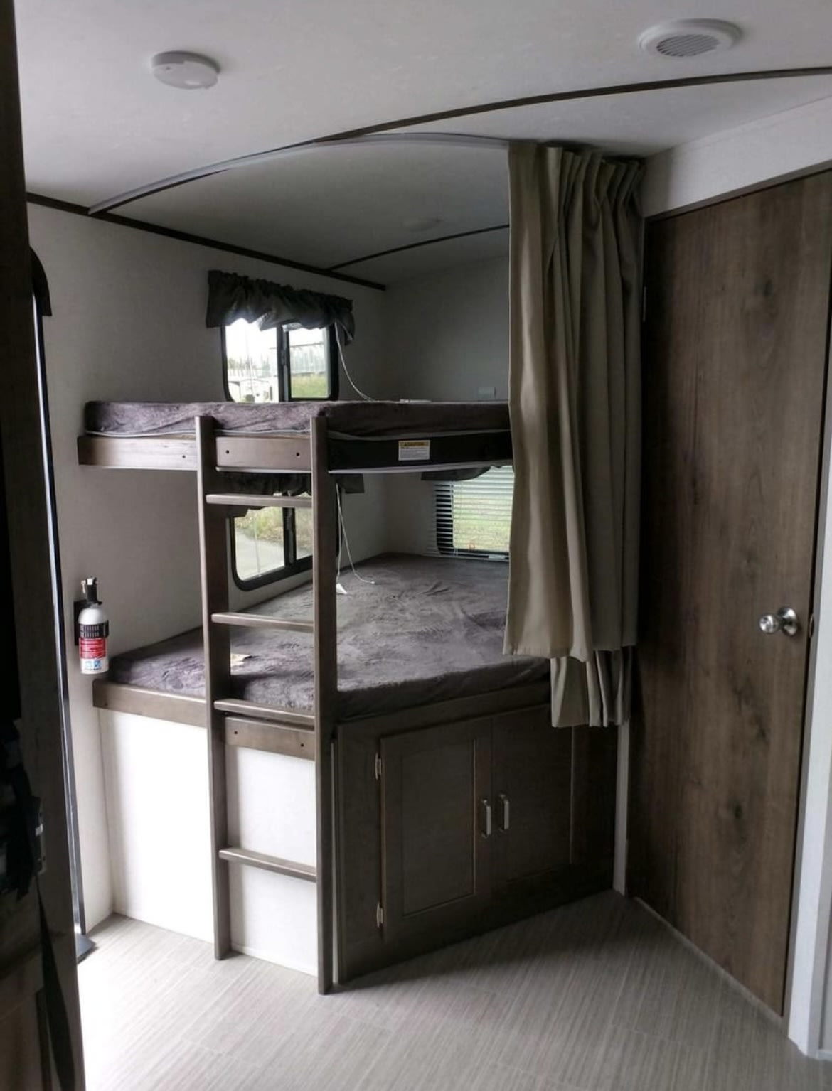 This **rv rental** features built-in bunk beds, a safety ladder, cabinet storage, and a fire extinguisher for travel.. Keystone RV Passport Grand Touring 2019