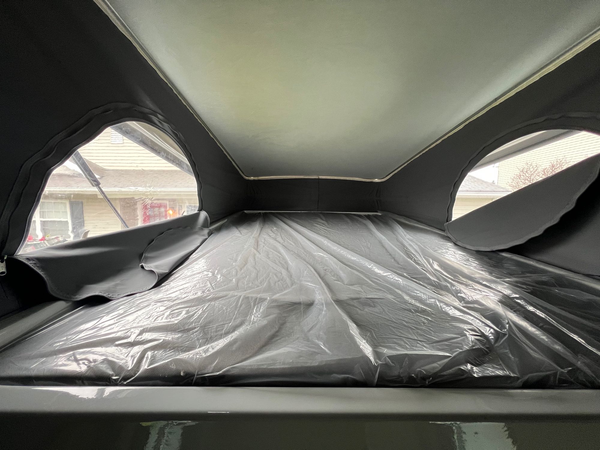 Pop-top RV rental: New sleeping loft, mattress wrapped in plastic, with residential views from side windows.. Winnebago Solis 59px 2023