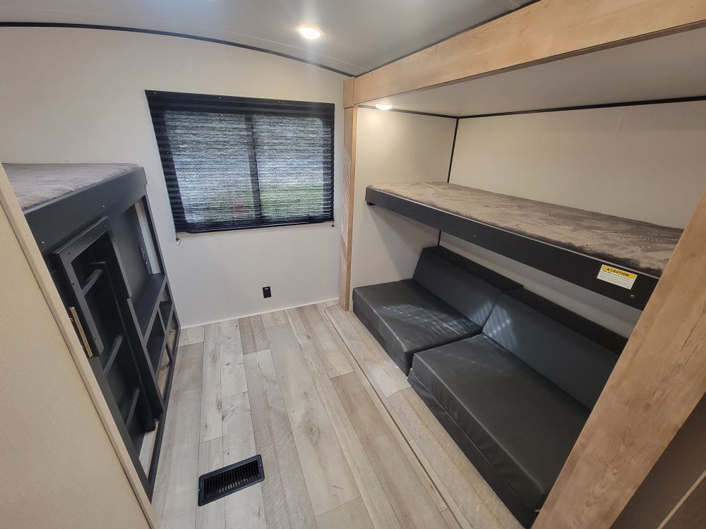 RV rental: Bunk beds, convertible sofa, and ample storage create a versatile bunkhouse.. Keystone RV Springdale 2023