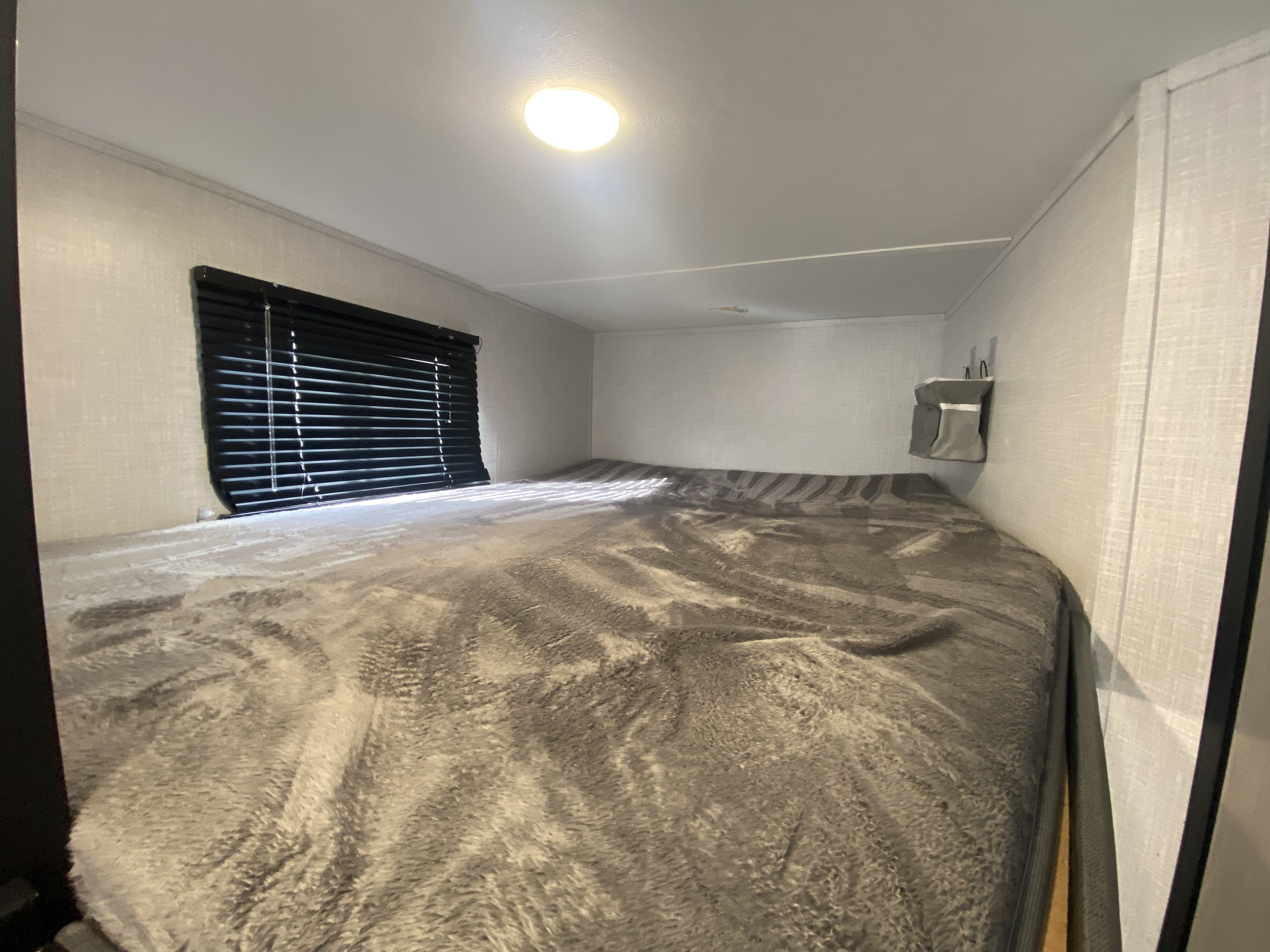 This is the top bunk there are two hanging compartments to hold personal items. And an overhead light.. Dutchmen Coleman Light 2022
