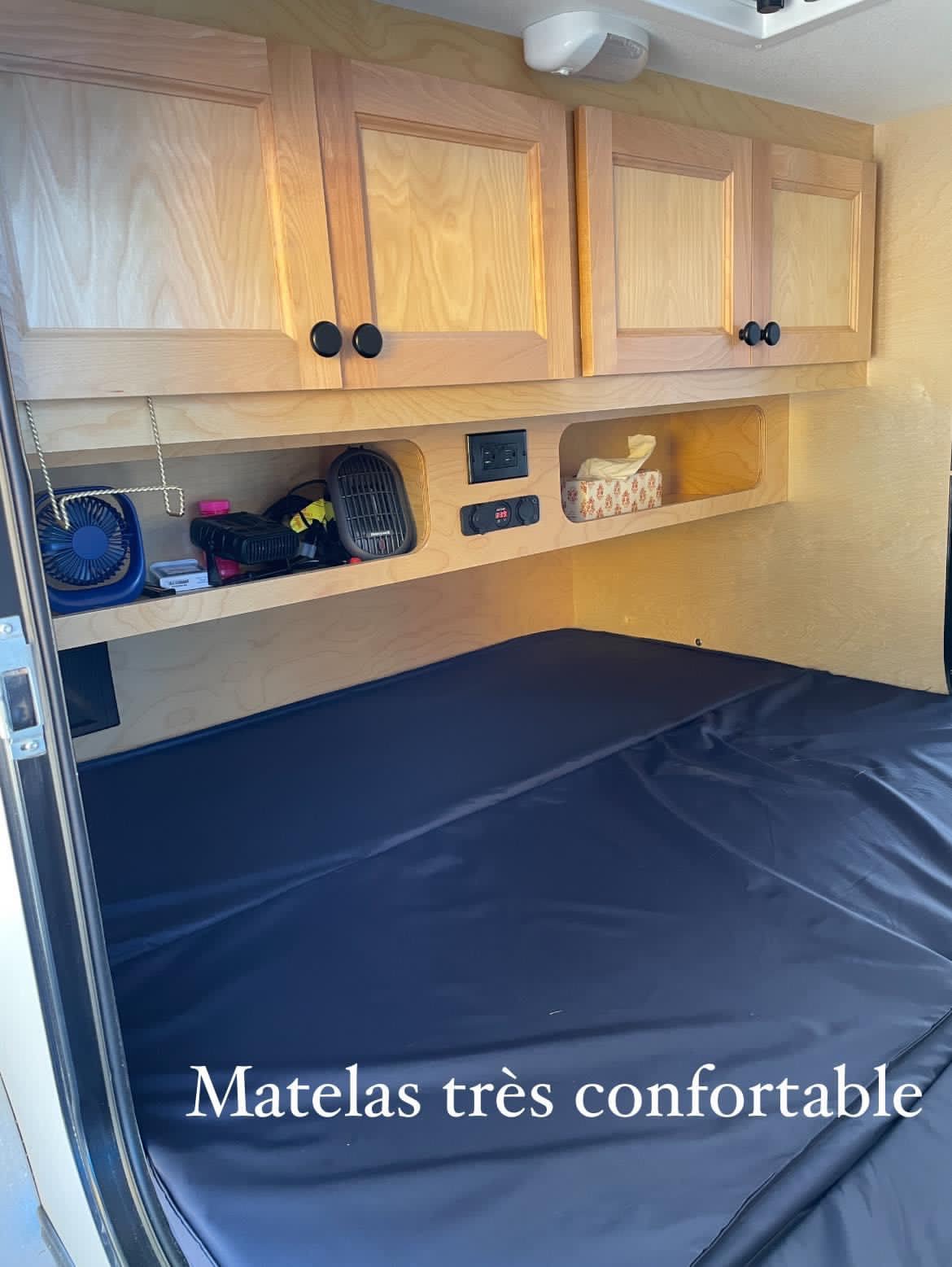 Explore this RV rental's well-equipped cabin: comfy mattress, wooden cabinets, and convenient power. Your travel haven.. Car-gotrailers liberty2goXL 2021