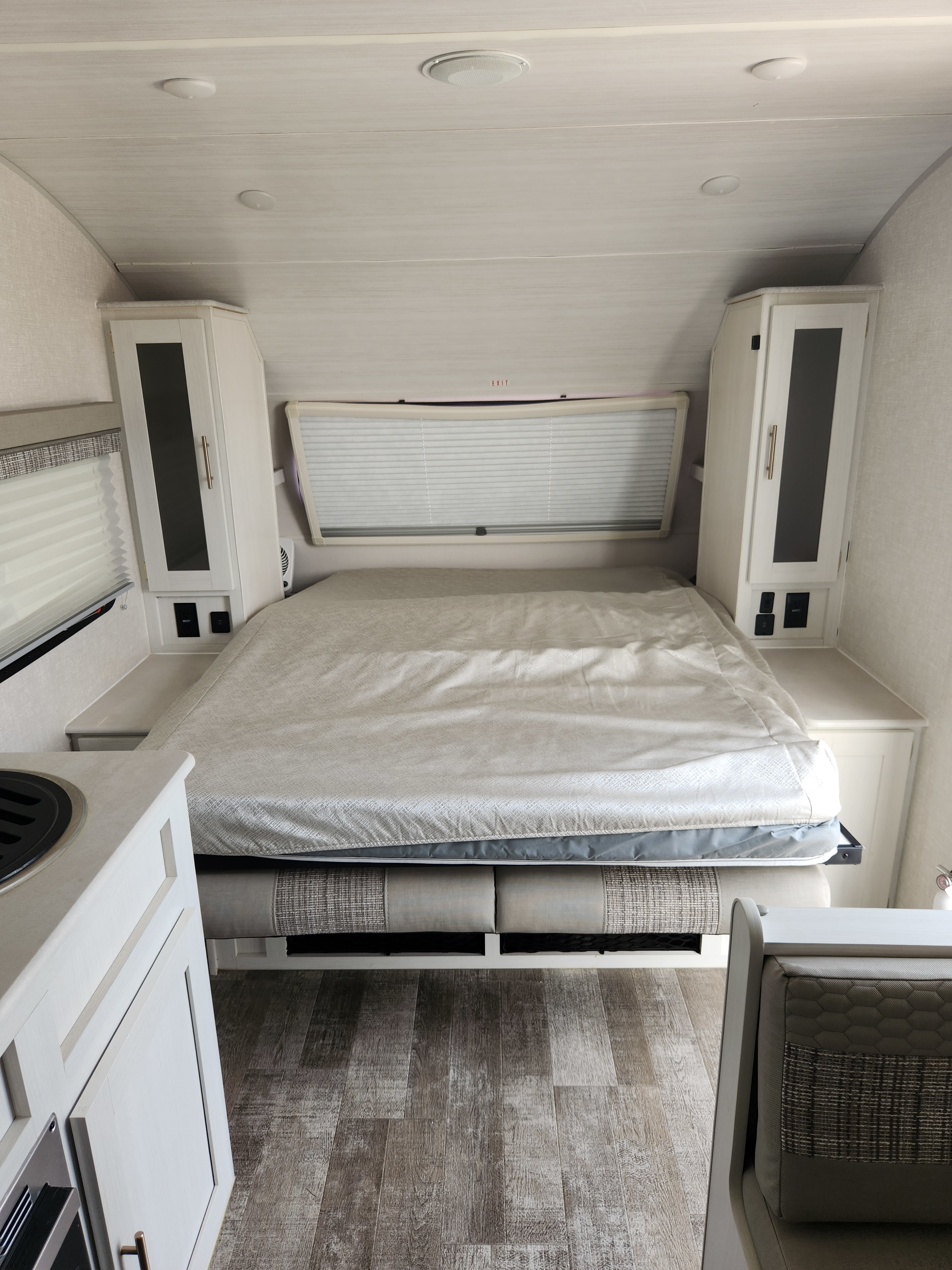 Inside this RV rental: a bright, modern bedroom area with a comfortable bed, ample storage, and light wood flooring.. R-Pod R-Pod Trailer 2022