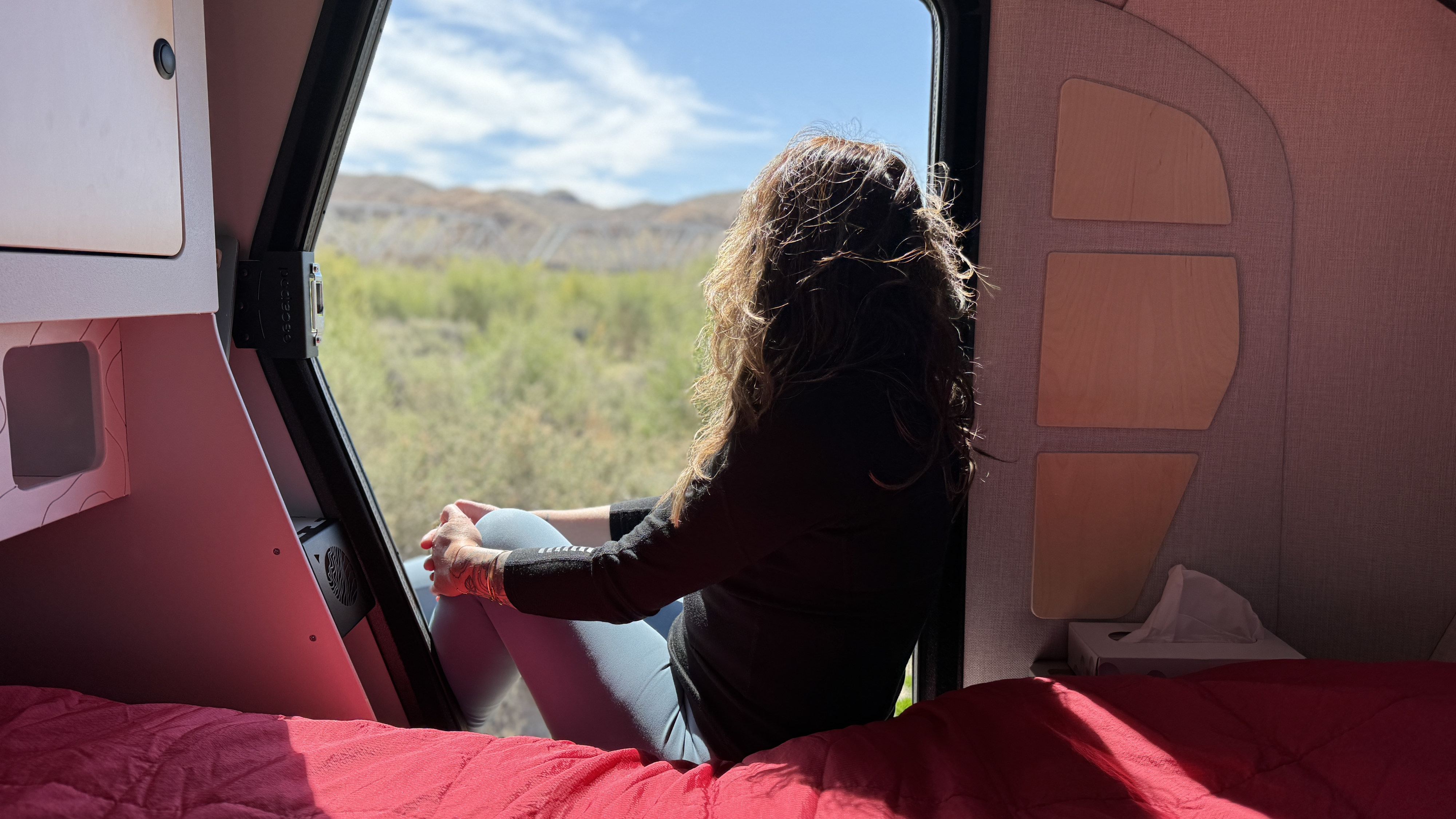 Cozy RV rental interior offers stunning nature views from the comfort of the bed, perfect for nature getaways.. Other Other 2024