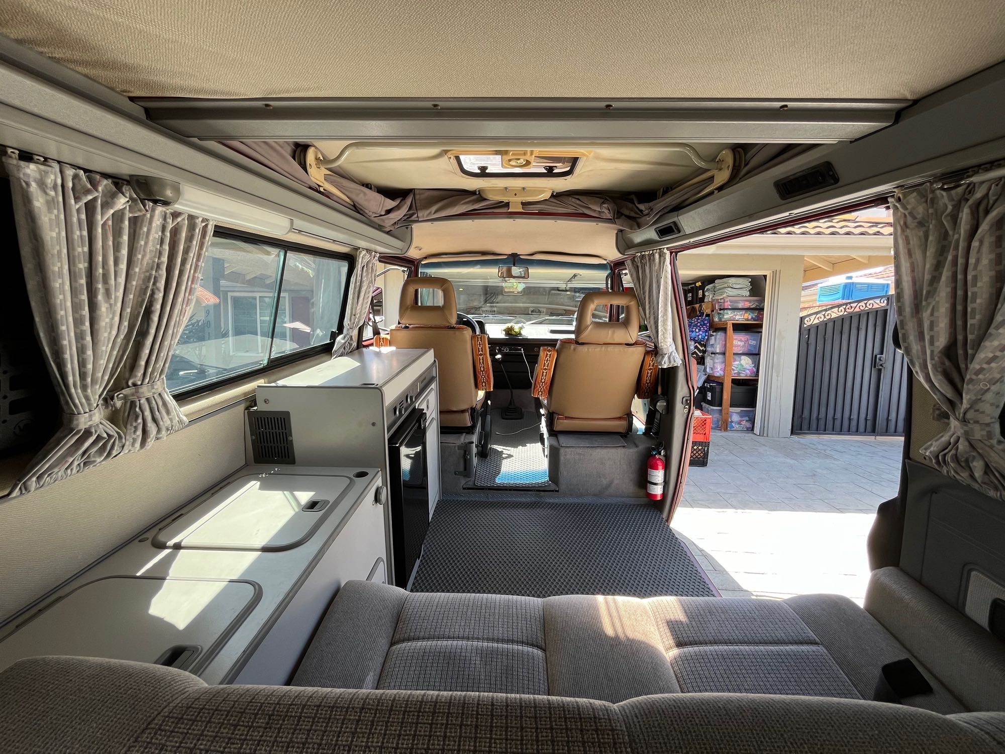 RV rental ready: Explore this camper van's cozy interior, featuring a kitchenette, rear seating, and front cabin.. Volkswagen Westfalia 1987