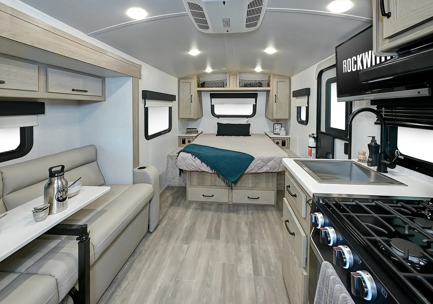 Spacious RV rental interior with a full kitchen, comfortable dinette, and bedroom area, perfect for travel.. Forest River Rockwood Geo Pro 2024